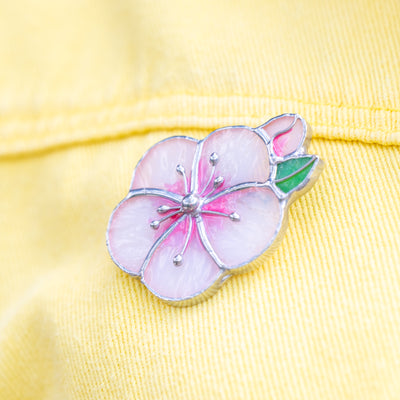 Stained glass apricot blossom brooch on yellow skirt