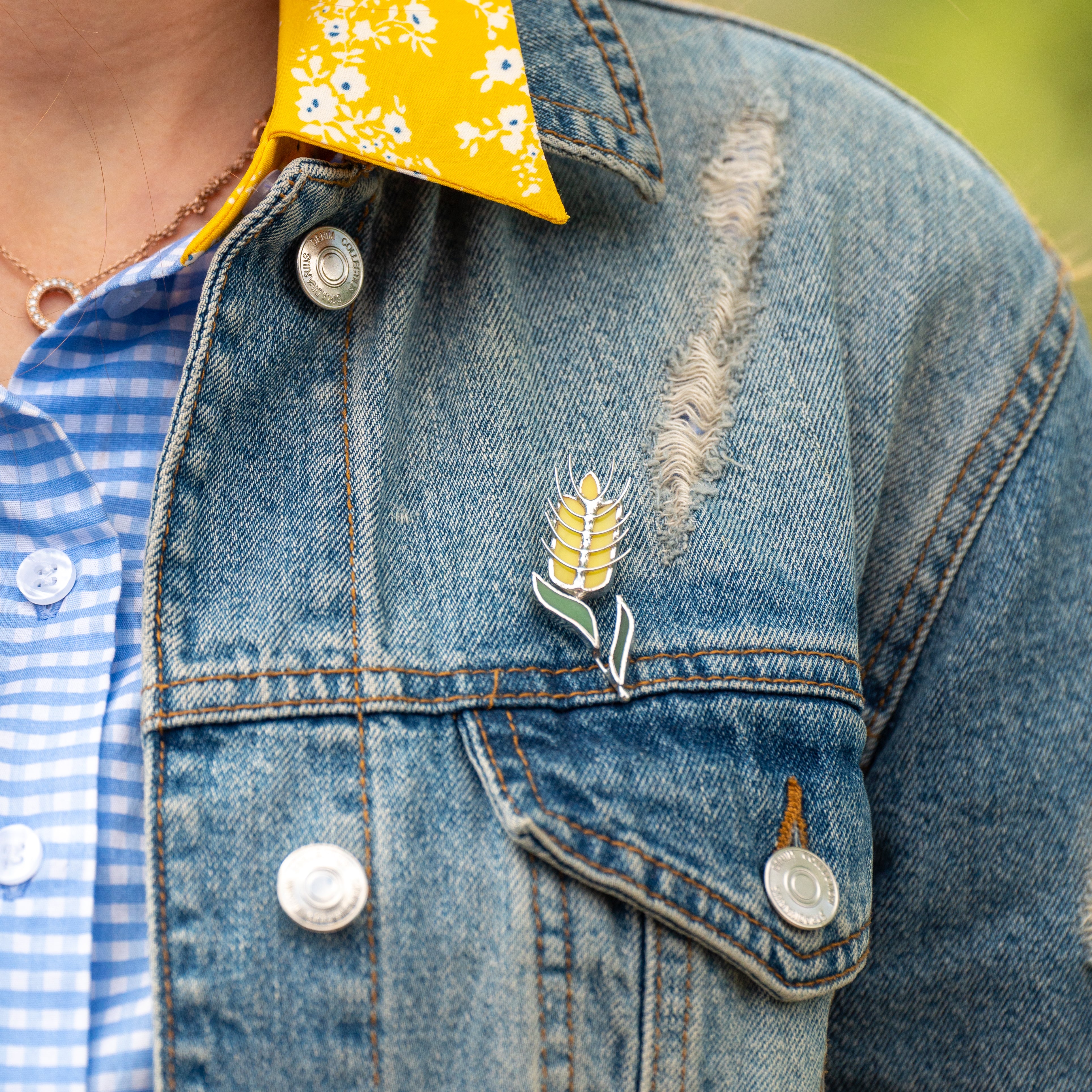 Stained glass wheat pin on a jeans jacket