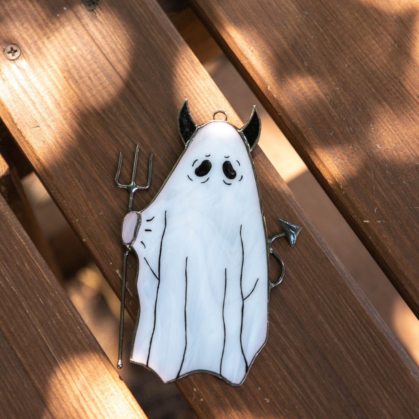 Ghost with pitchfork window hanging of stained glass