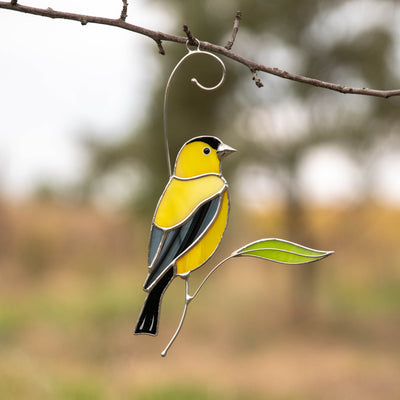 Bright stained glass goldfinch on the branch suncatcher