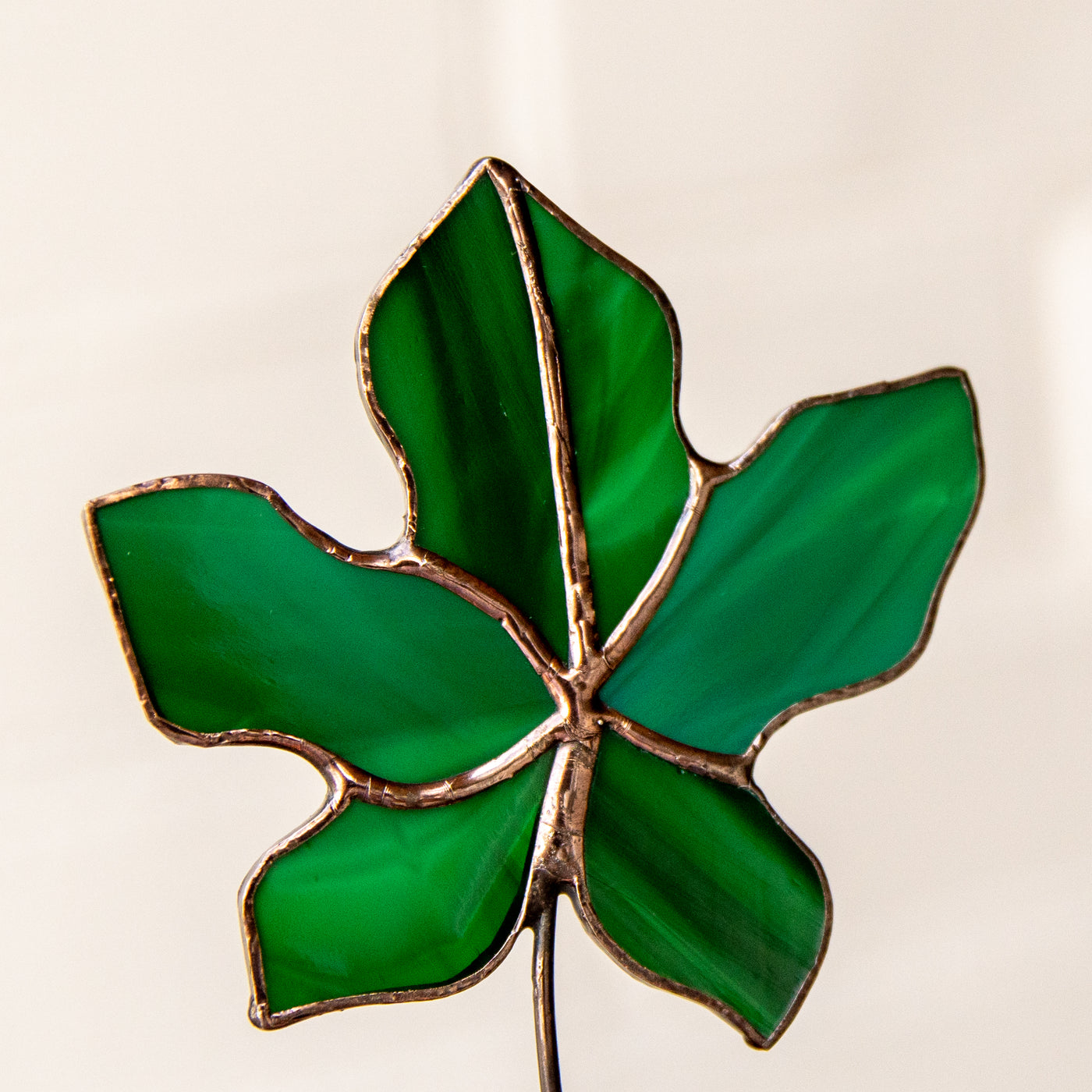 Zoomed stained glass green maple leaf 