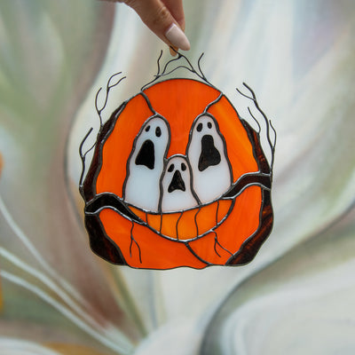 Stained glass ghost-eyed pumpkin suncatcher for spooky Halloween decor