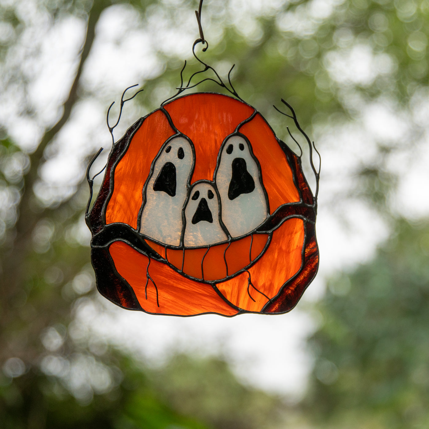 Stained glass pumpkin with ghost-eyes window hanging 