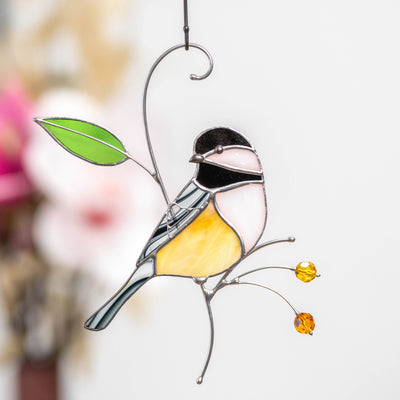 Stained glass chickadee sitting on the branch with leaves and berries window hanging