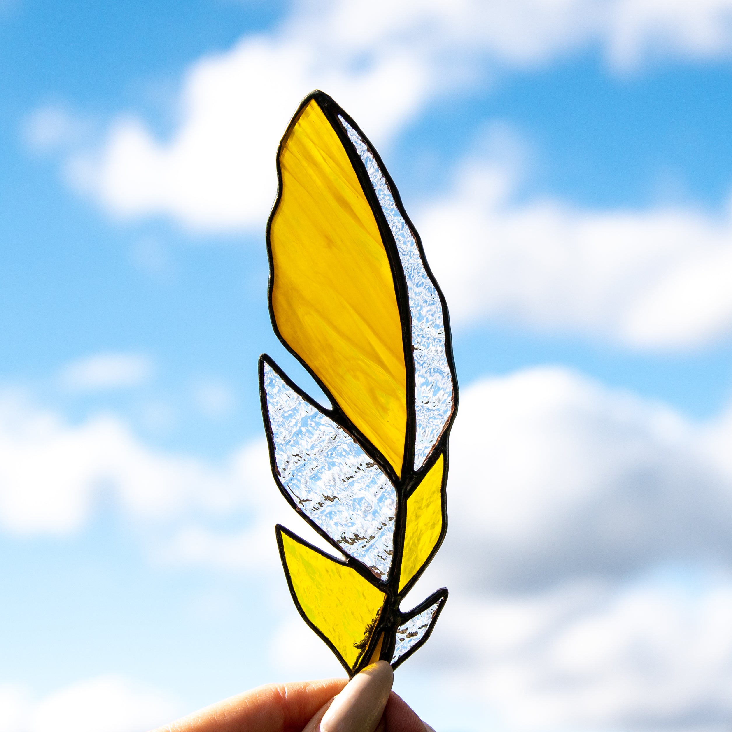 Stained glass yellow feather suncatcher with clear parts
