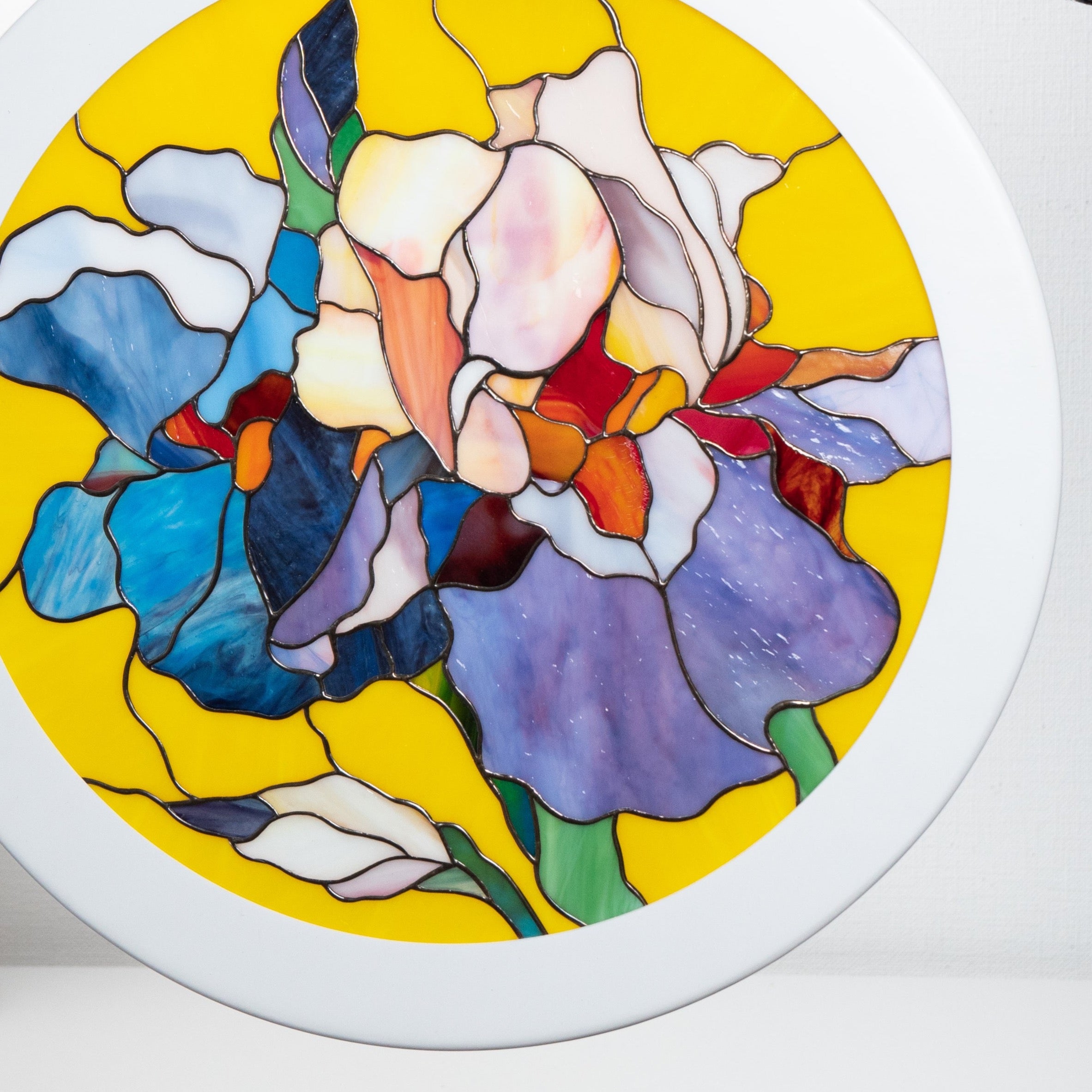 Zoomed stained glass round panel depicting irises