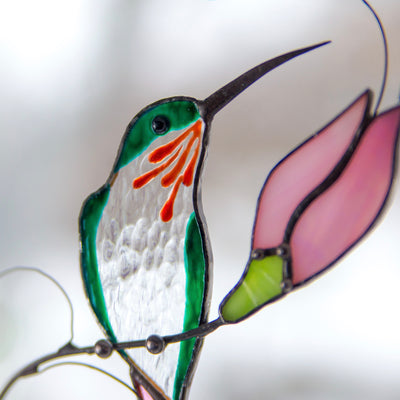 Zoomed stained glass hummingbird with pink flower window hanging