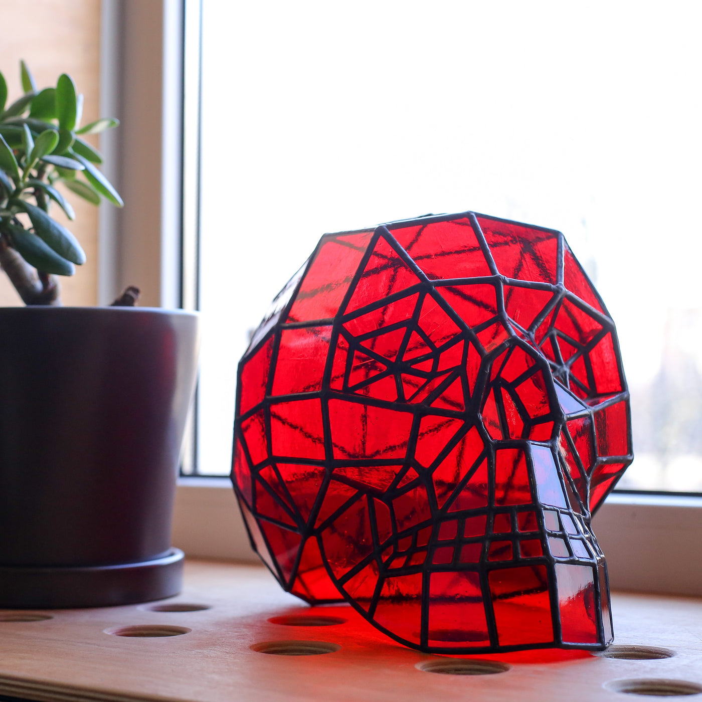 Red-coloured stained glass 3D human skull for ghastly Halloween 
