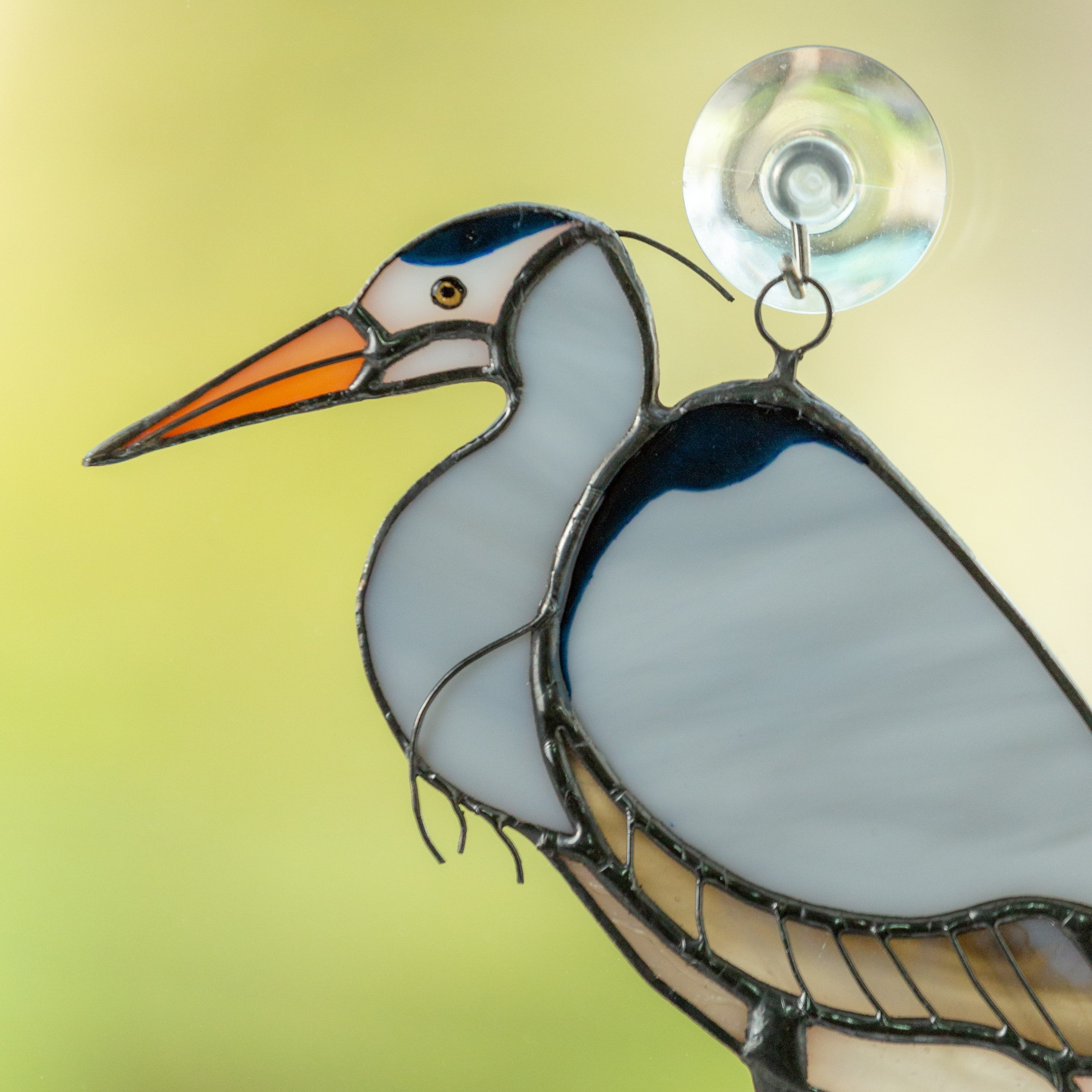 Zoomed stained glss blue heron window hanging