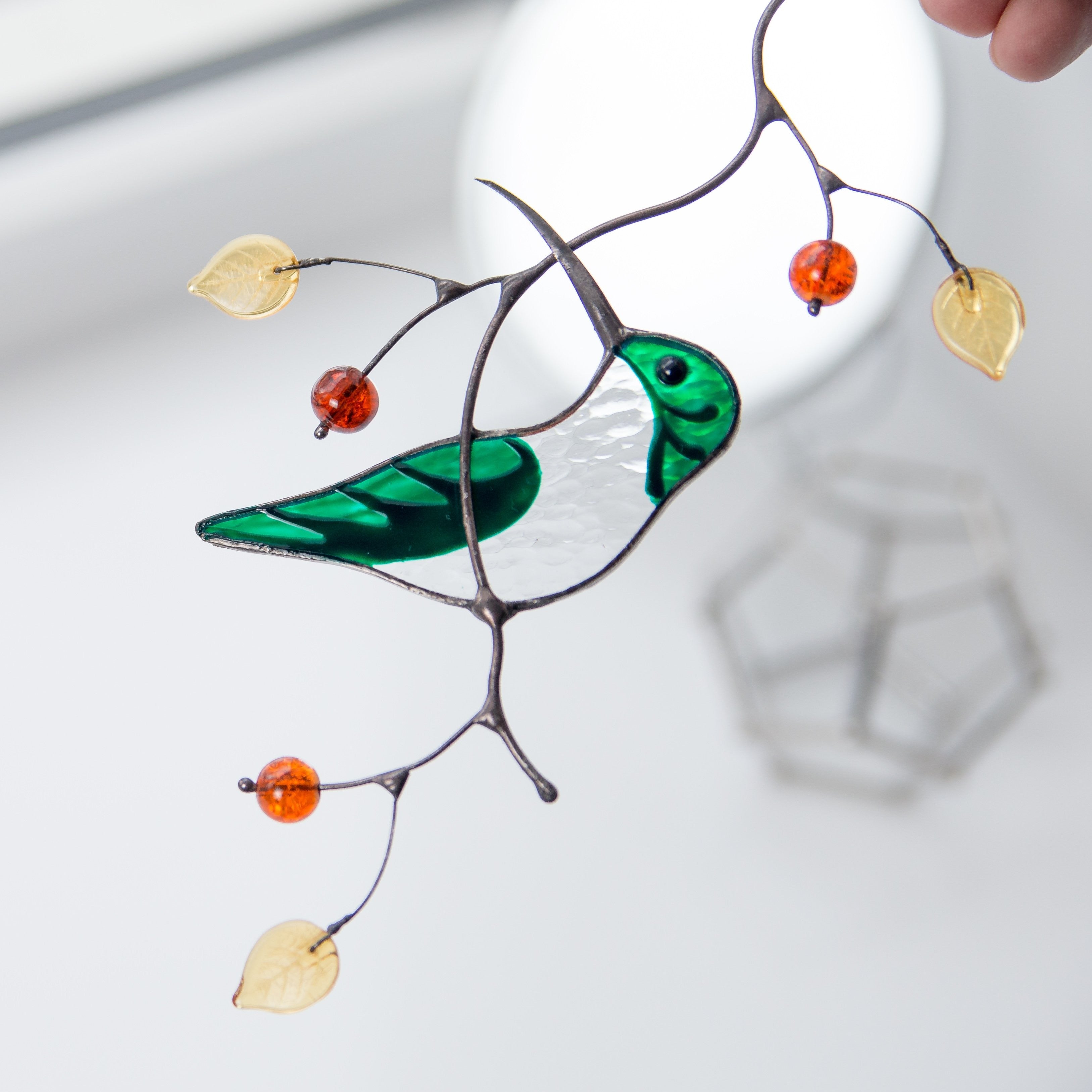 Stained glass green female hummingbird on the branch suncatcher