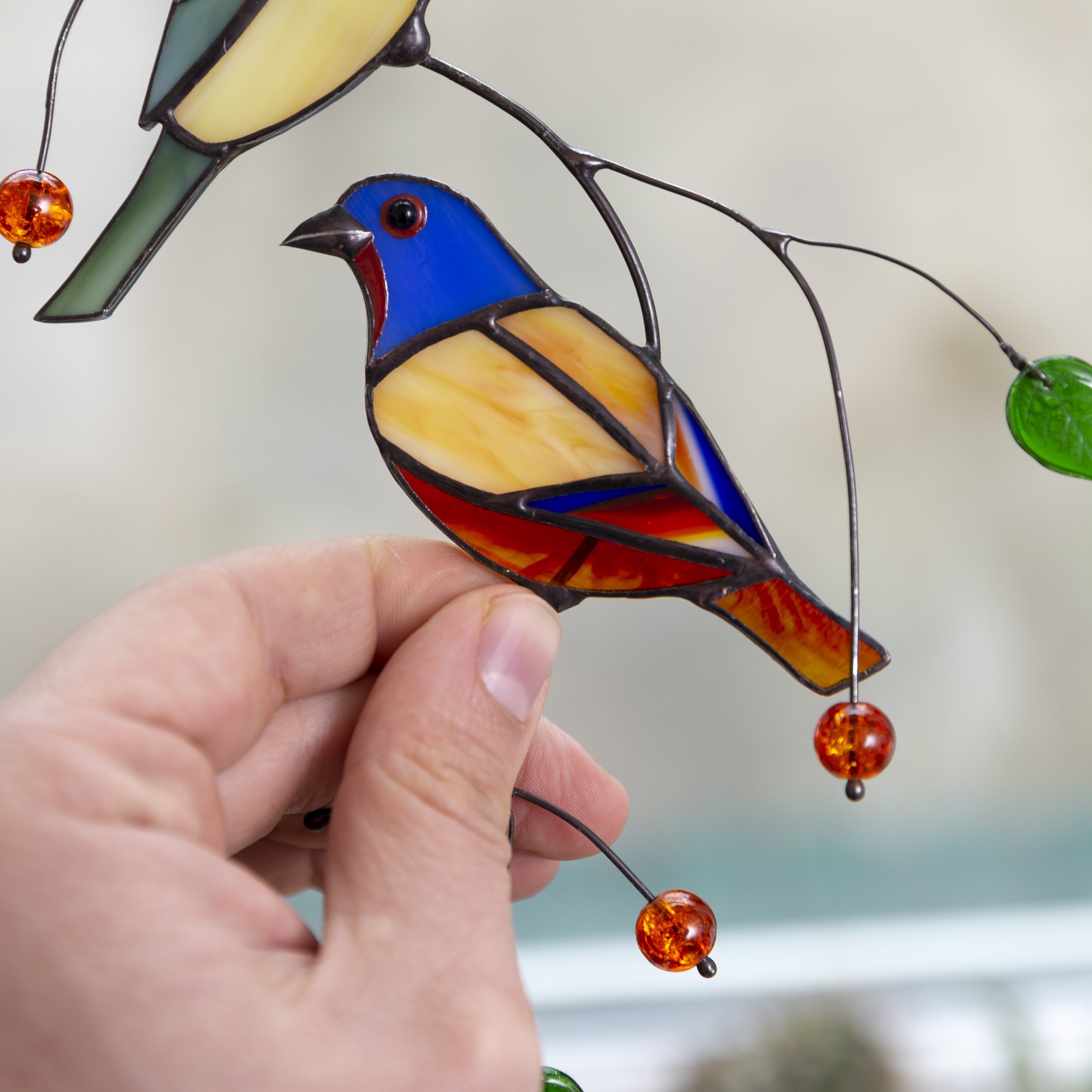 Zoomed stained glass lower bunting bird window hanging