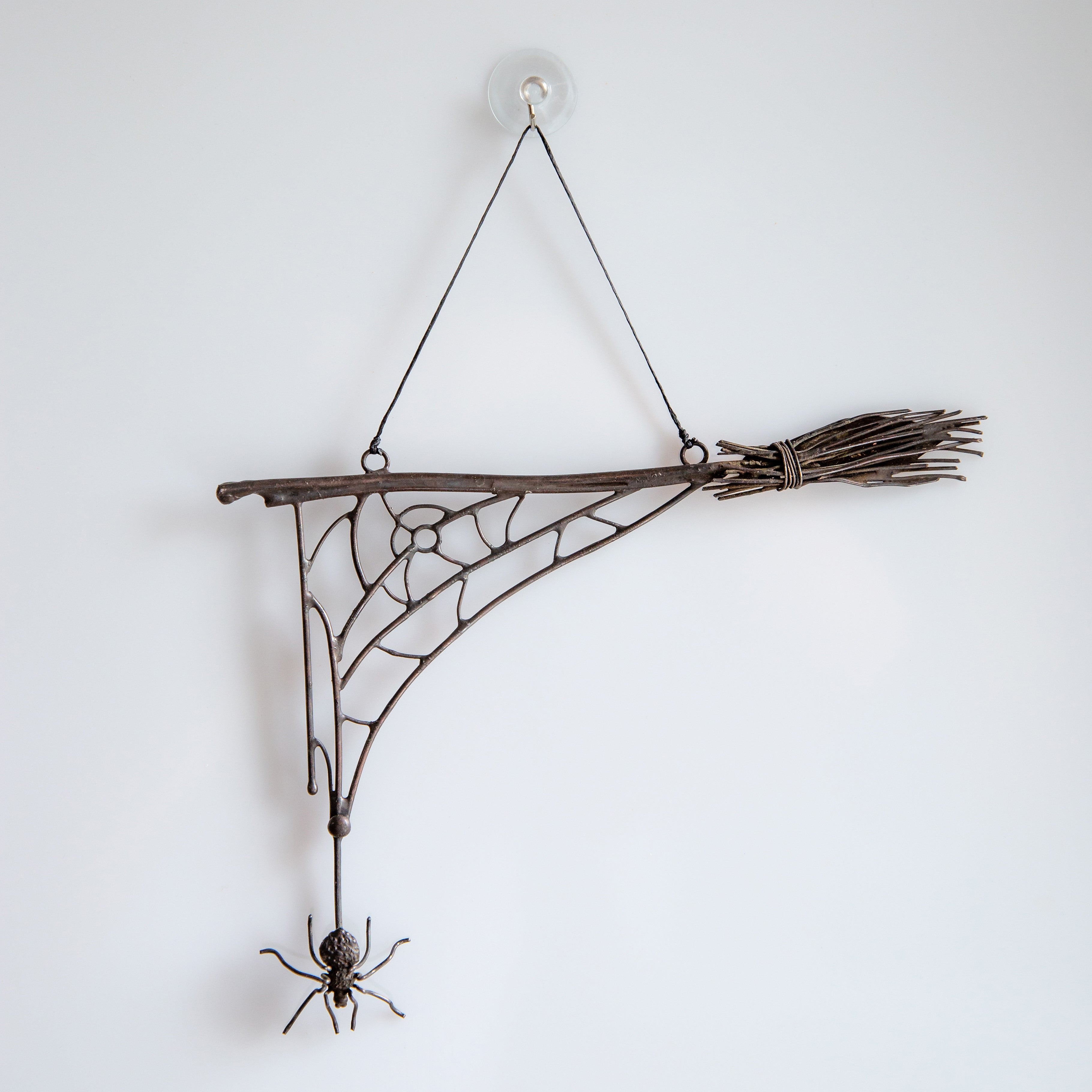 Spooky spider web with the spider and the broom for Halloween