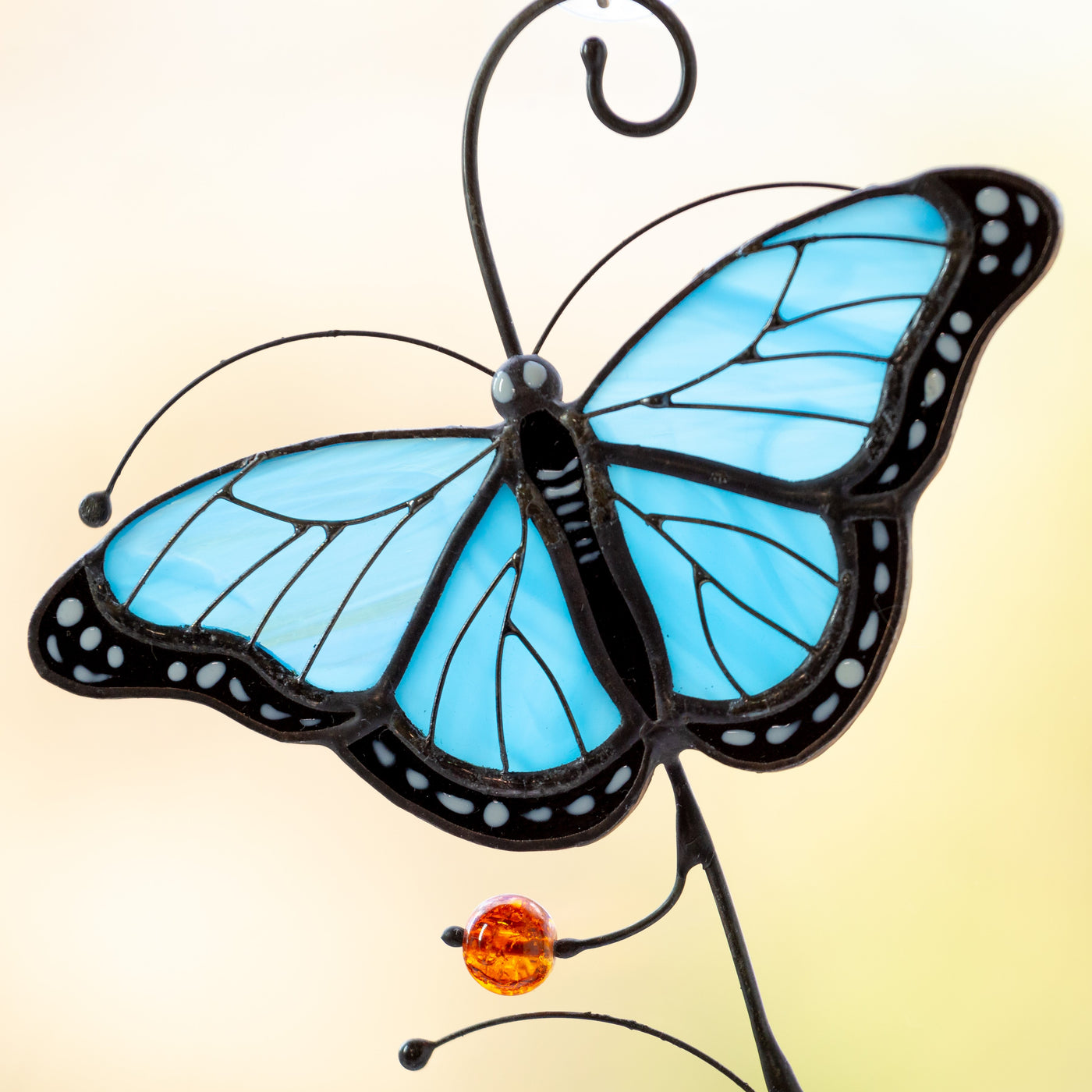 Zoomed stained glass blue butterfly window hanging