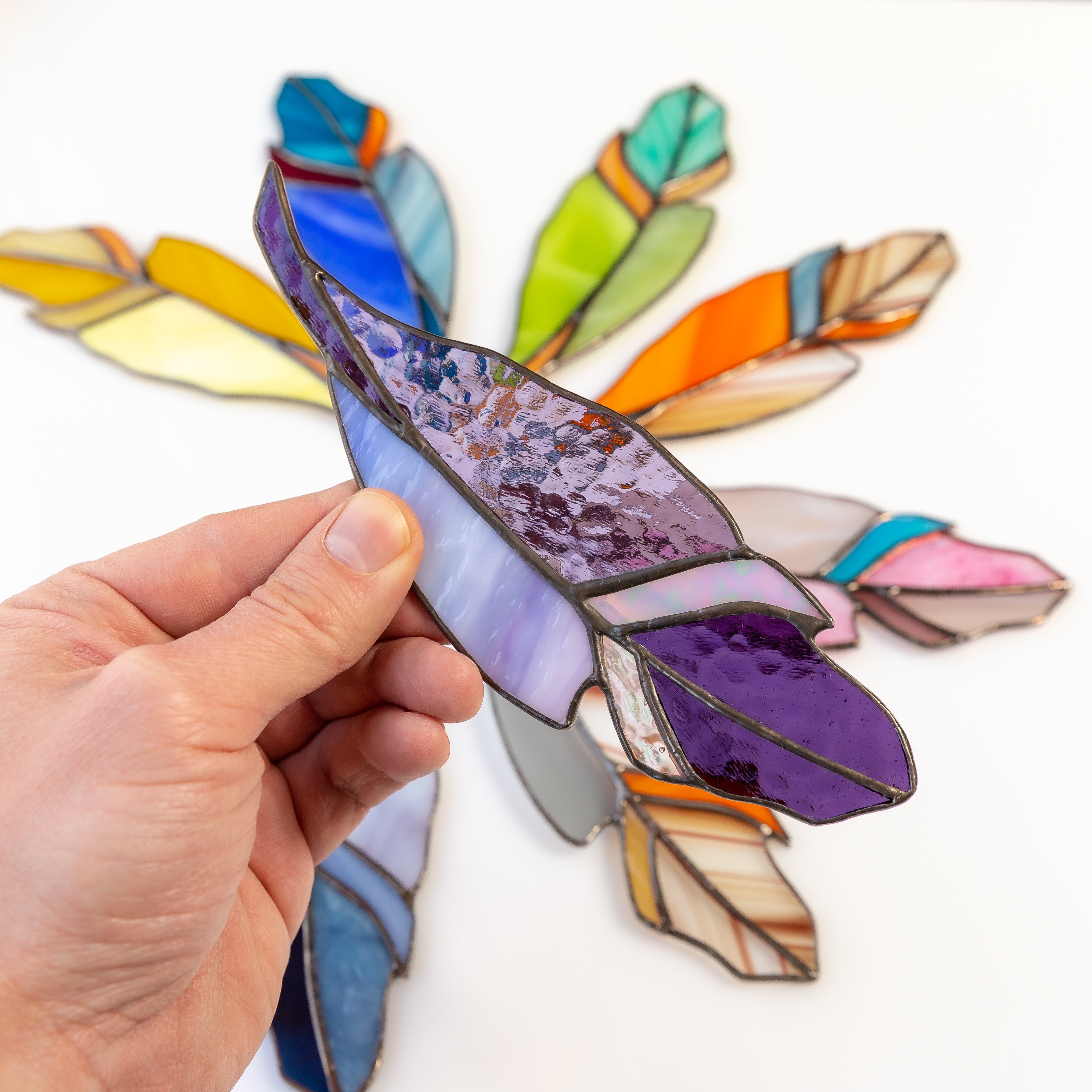 Purple feather window hanging of stained glass