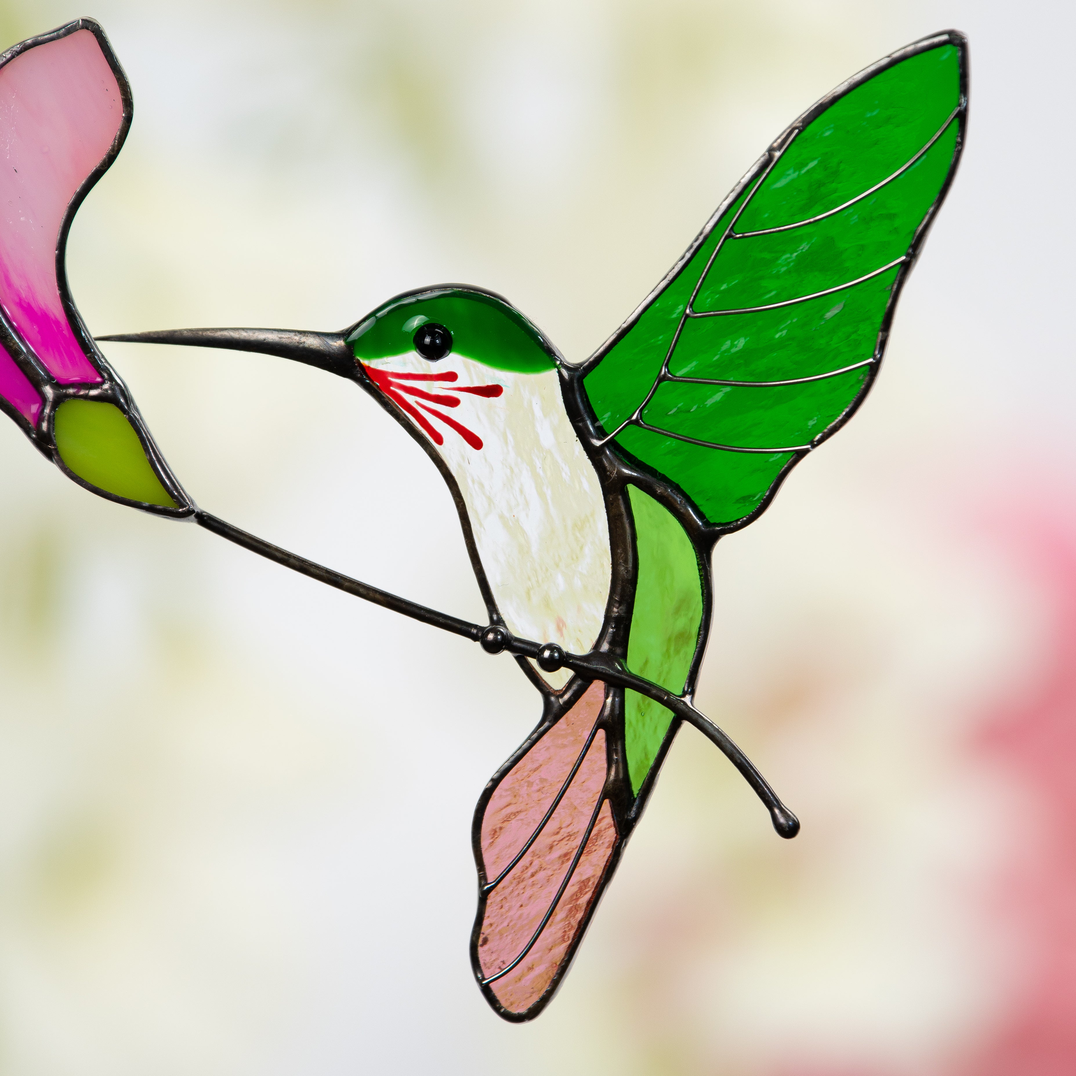 Zoomed stained glass flying hummingbird