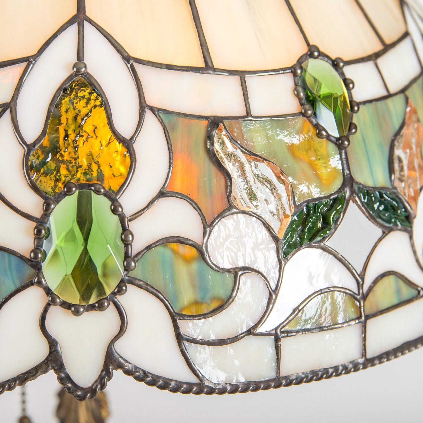 Zoomed stained glass lamp shade with green inserted gems 
