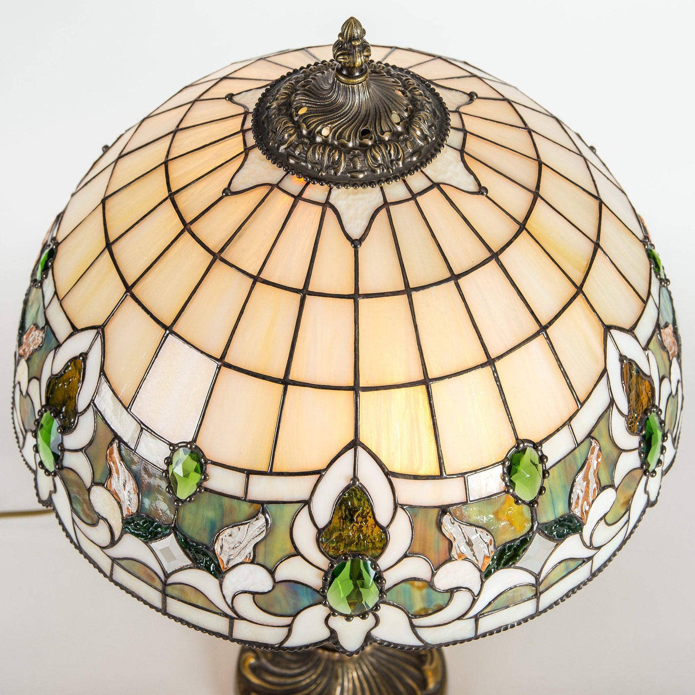 Top view of stained glass Tiffany lamp in beige and green colours