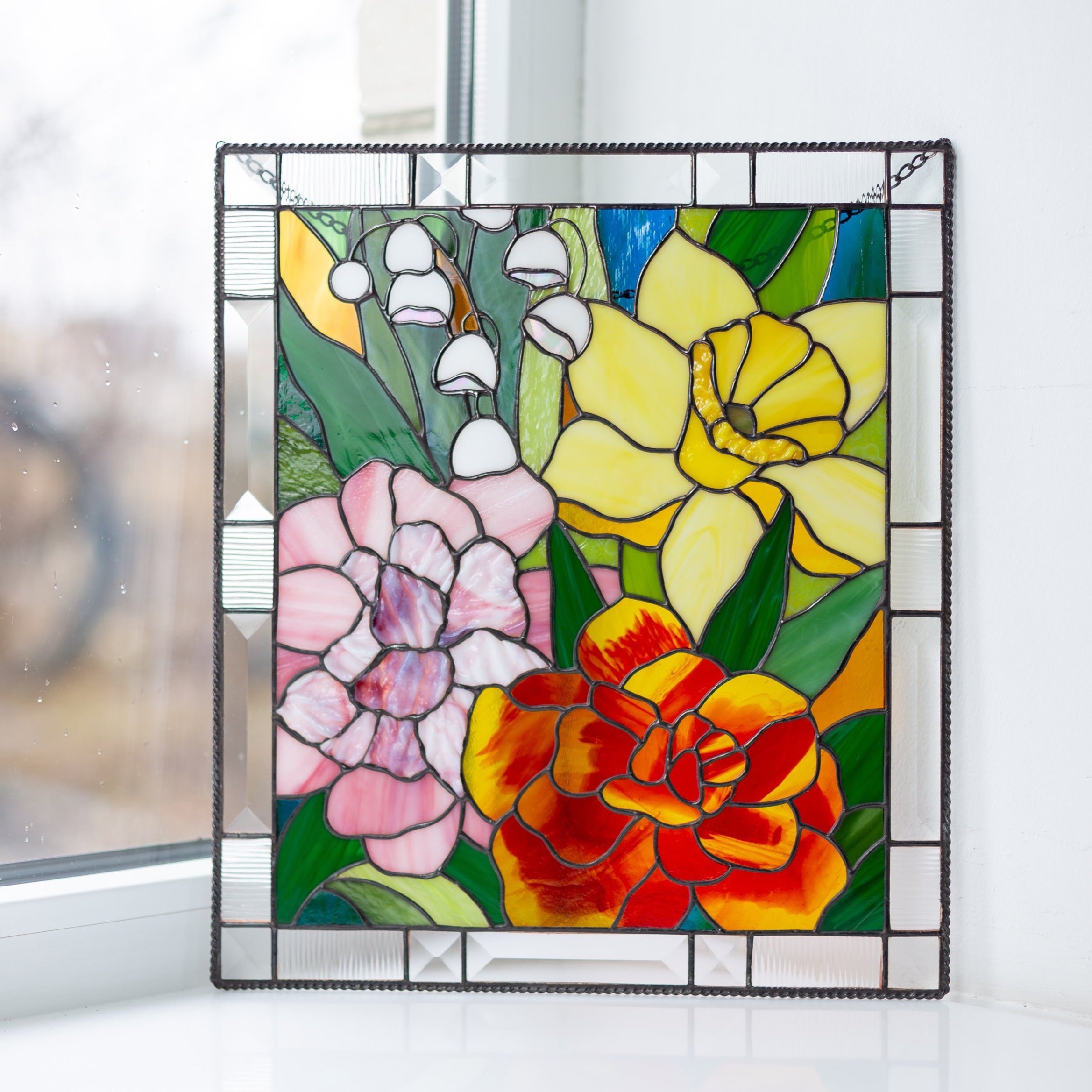 Stained glass panel depicting marigold, daffodil, carnations and lily window hanging