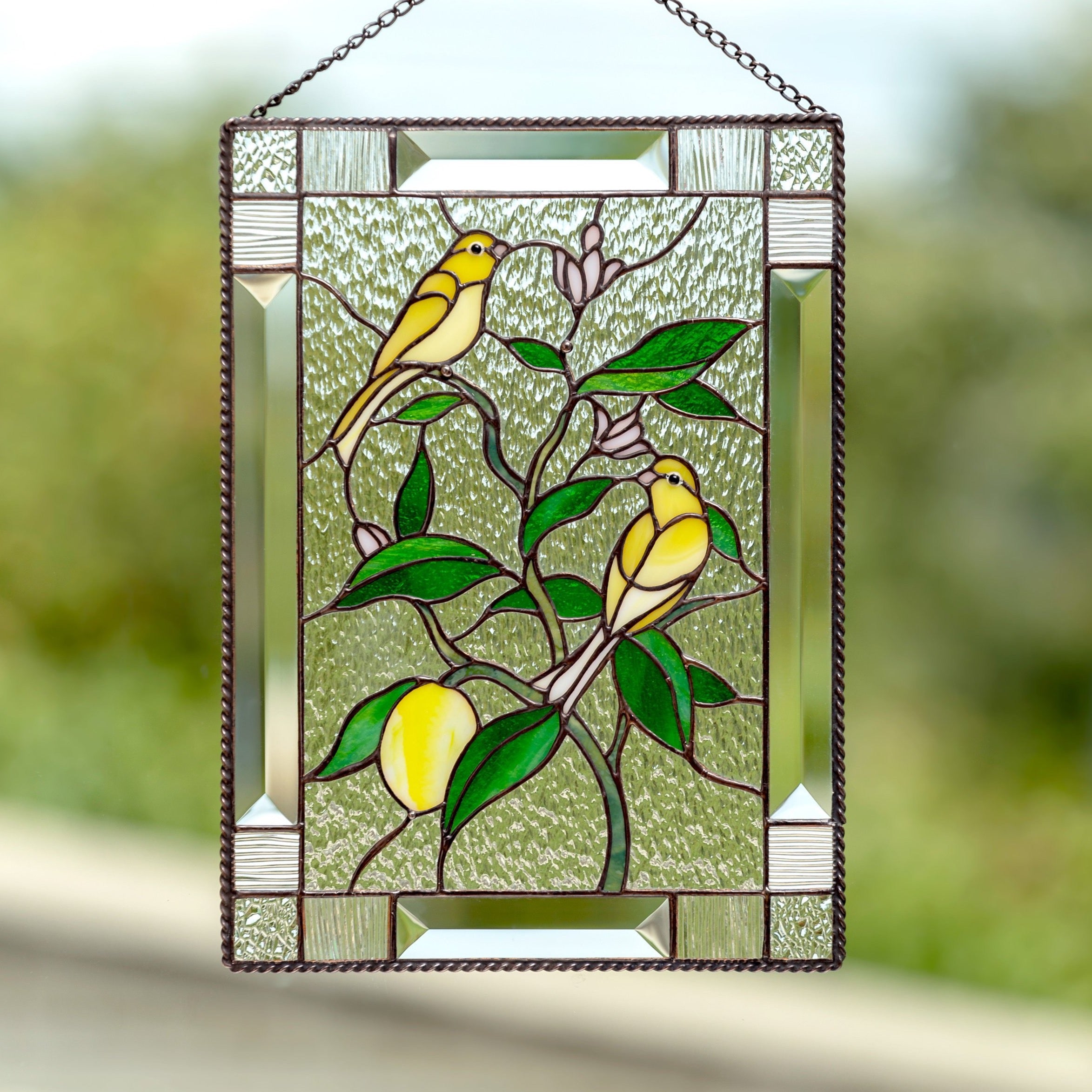 Stained glass canary birds sitting on the lemon tree panel