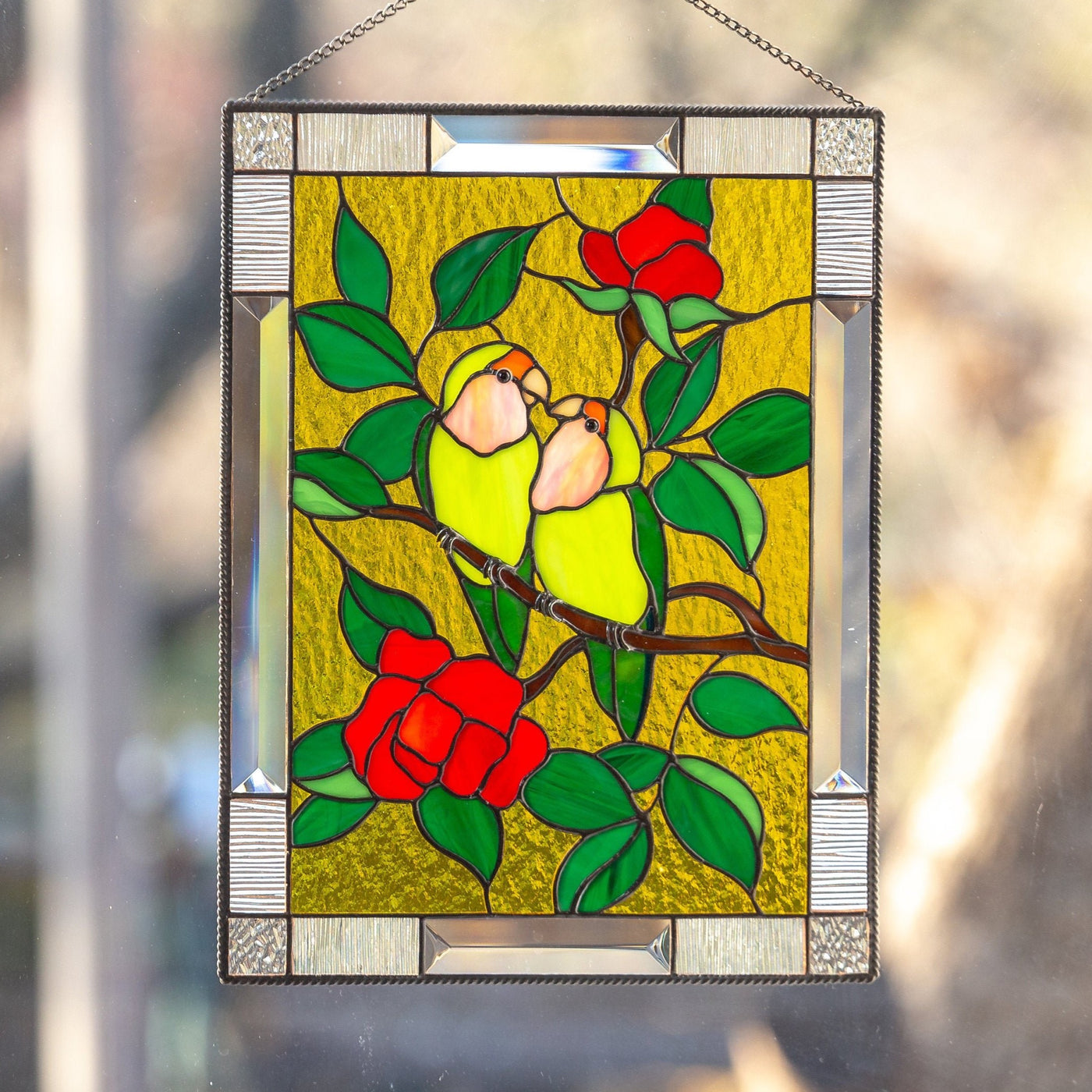 Stained glass panel depicting lovebirds sitting on the branch with flowers