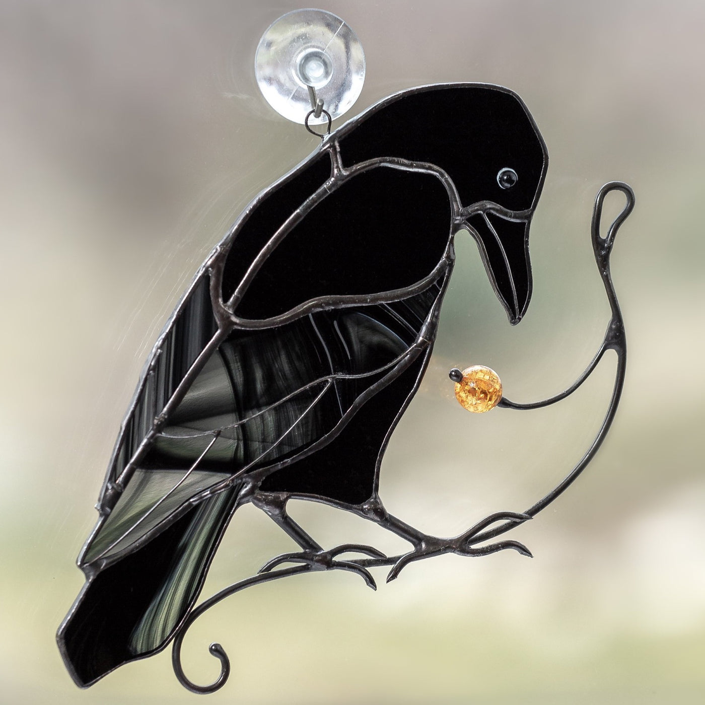 Zoomed stained glass raven on the branch with berry suncatcher for window 