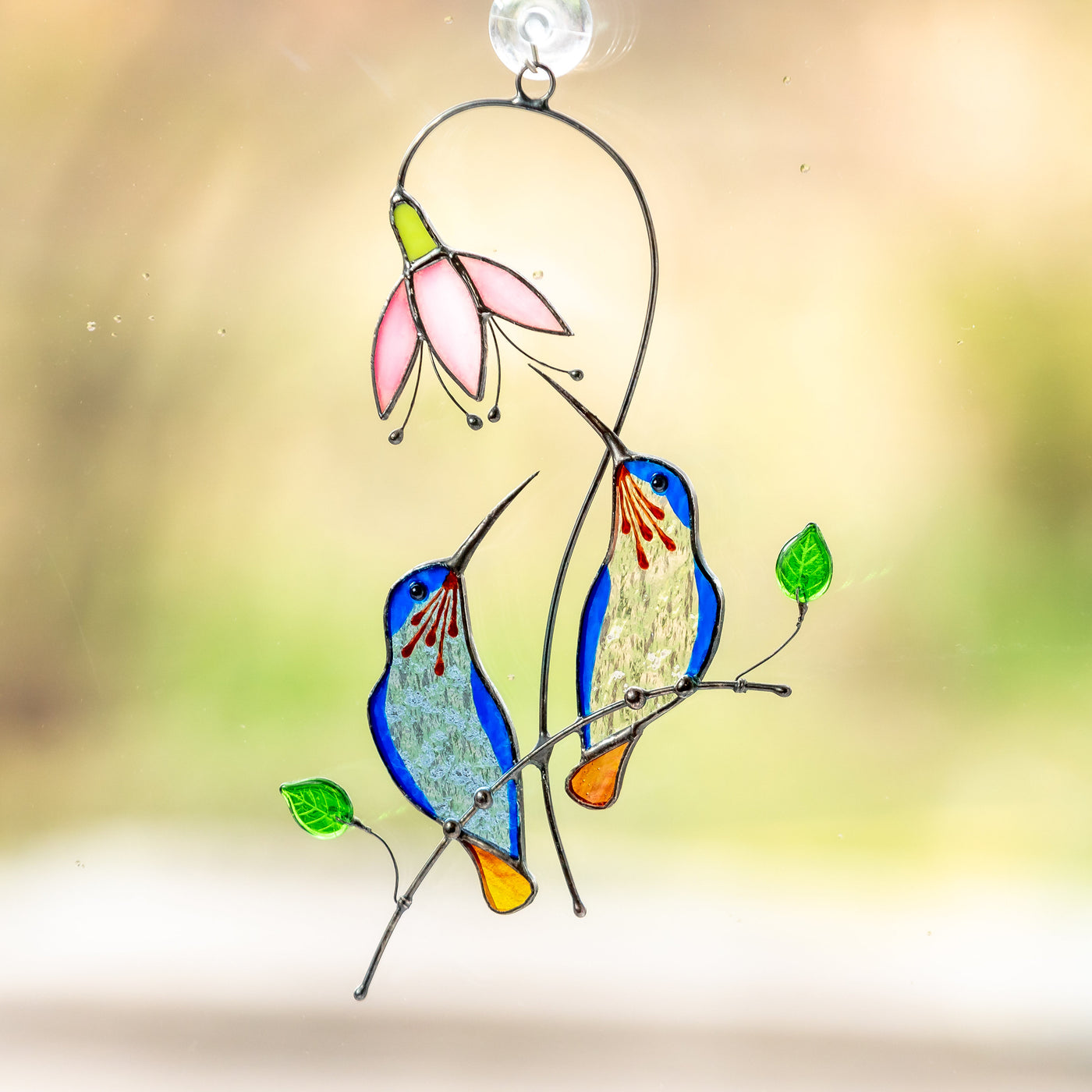 Pair of blue hummingbirds on the branch with pink flowers window hanging