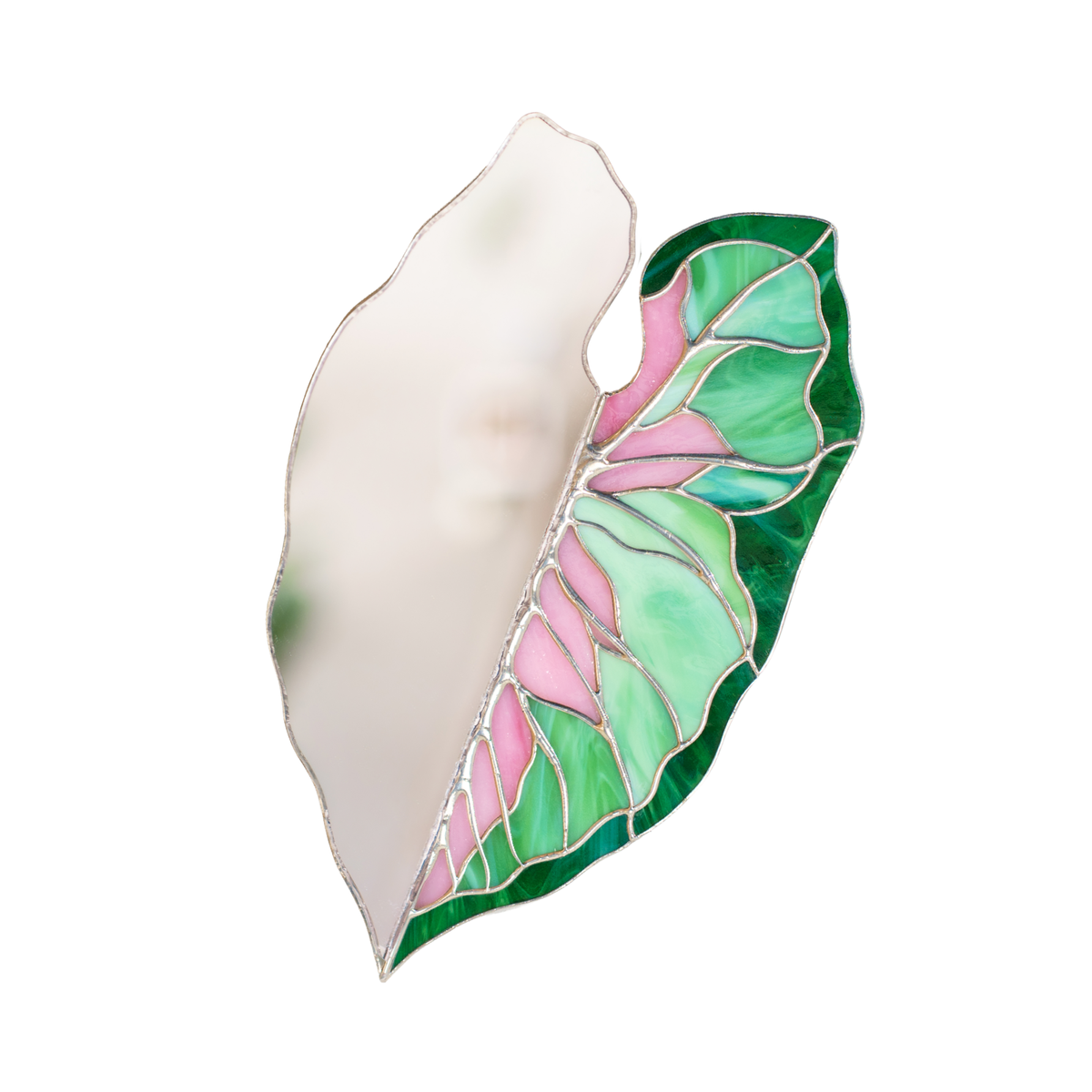 Caladium Leaf Stained Glass Mirror on a white background - one half mirror, the other pink, mint and emerald green glass with silver soldered veins, a handmade stained glass wall mirror