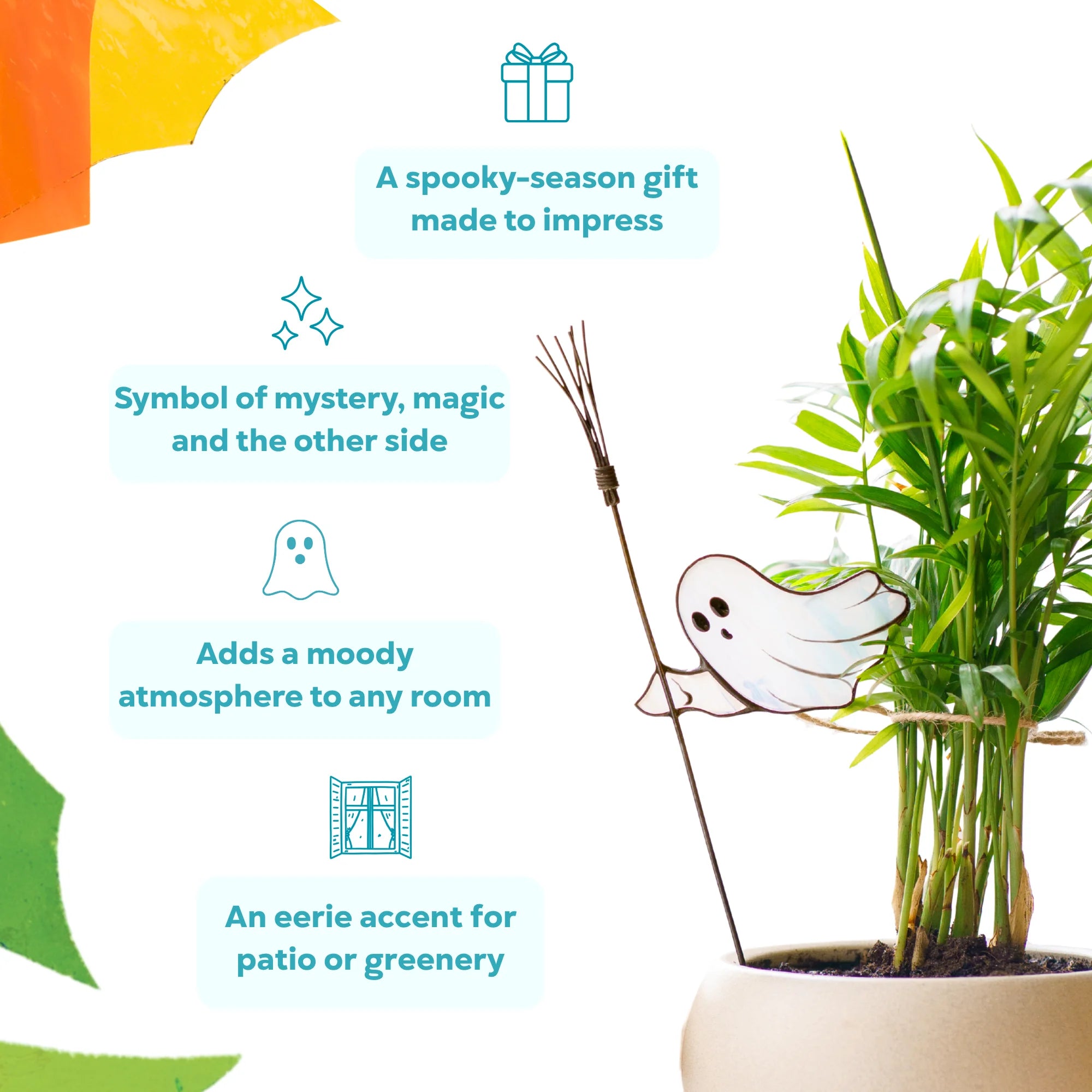 Stained glass ghost plant stake with a twig broom beside a green palm - a spooky-season gift and a symbol of mystery and magic that adds a moody accent to any room or patio