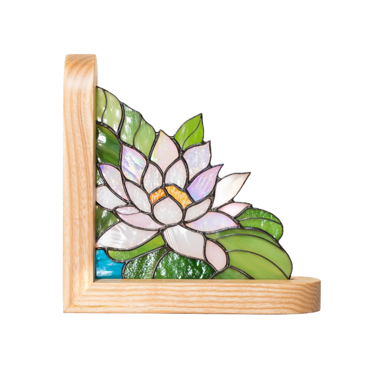 Water Lily stained glass bookend on white background, showing iridescent pink and white petals, green lily pad leaves and a teal glass water strip set in a natural ash wood corner frame