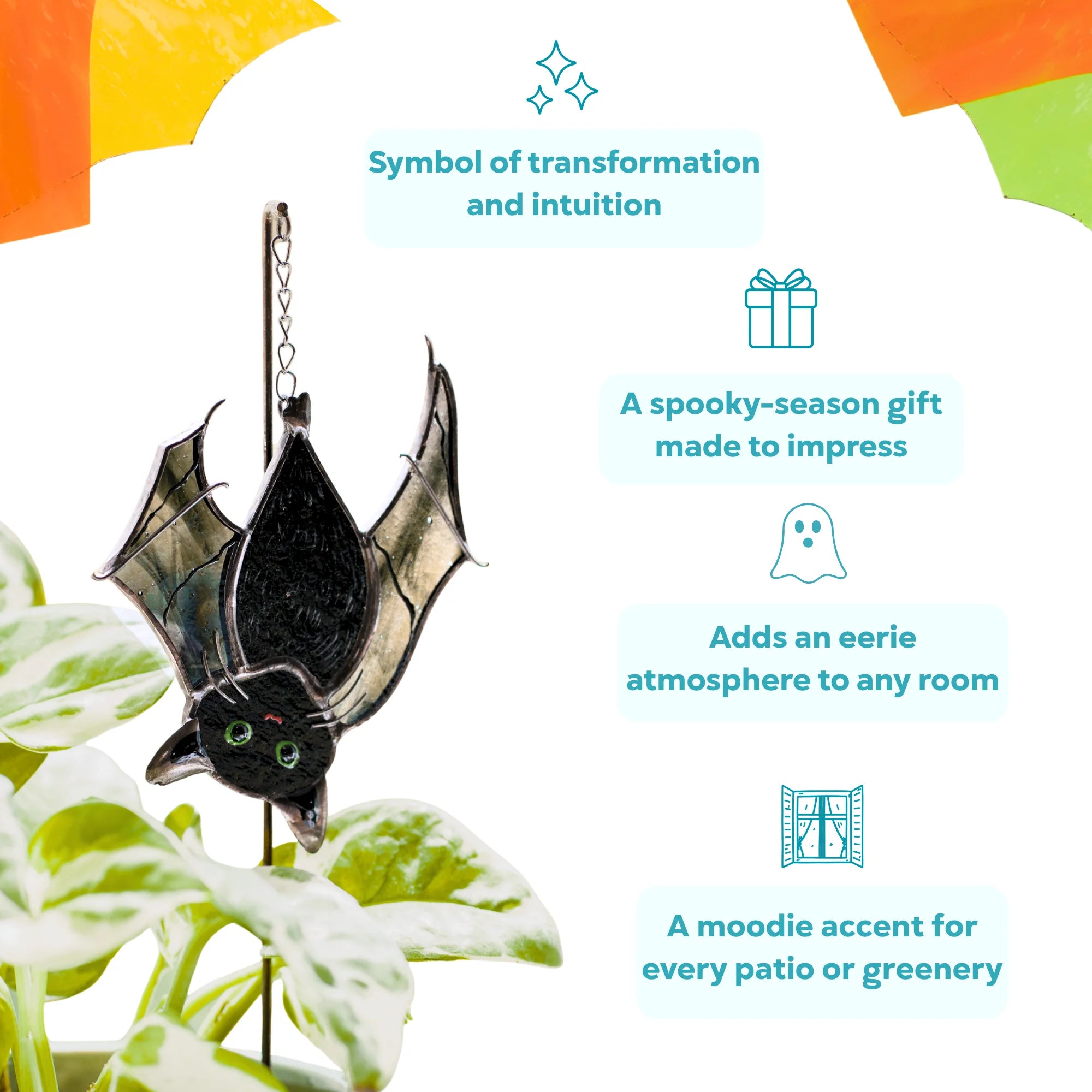 Stained glass cat-bat plant stake hanging over a variegated pothos - a symbol of transformation and intuition, a spooky-season gift and an eerie accent for any room or patio