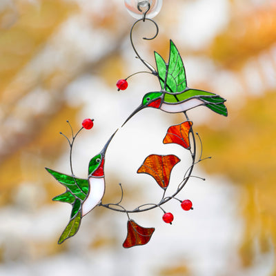 Stained glass suncatcher of two flying hummingbirds