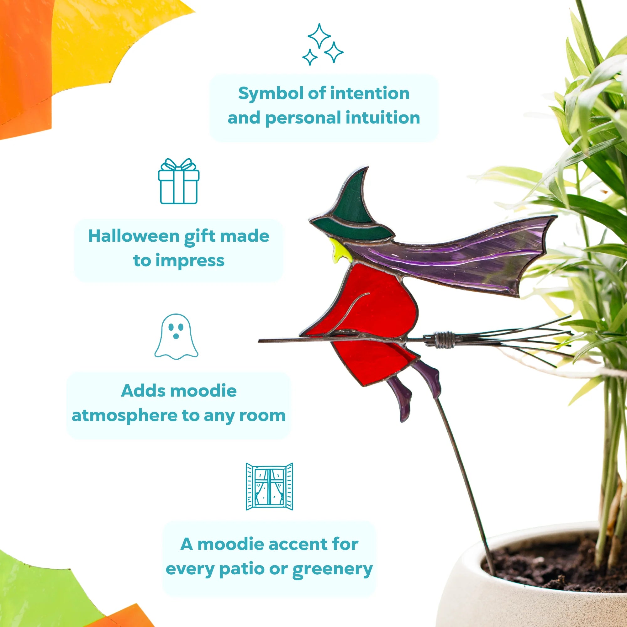 Stained glass witch plant stake on a wire broom beside a green palm - a symbol of intention and intuition, a Halloween gift and a moody accent for any room or patio