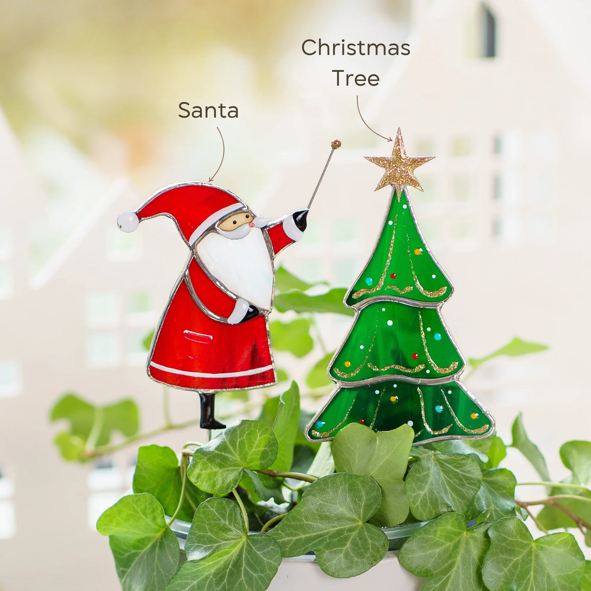 Santa with a magic wand and a green Christmas tree with a gold star - two handmade stained glass plant stakes in a pot of ivy, festive Christmas decor for houseplants and planters