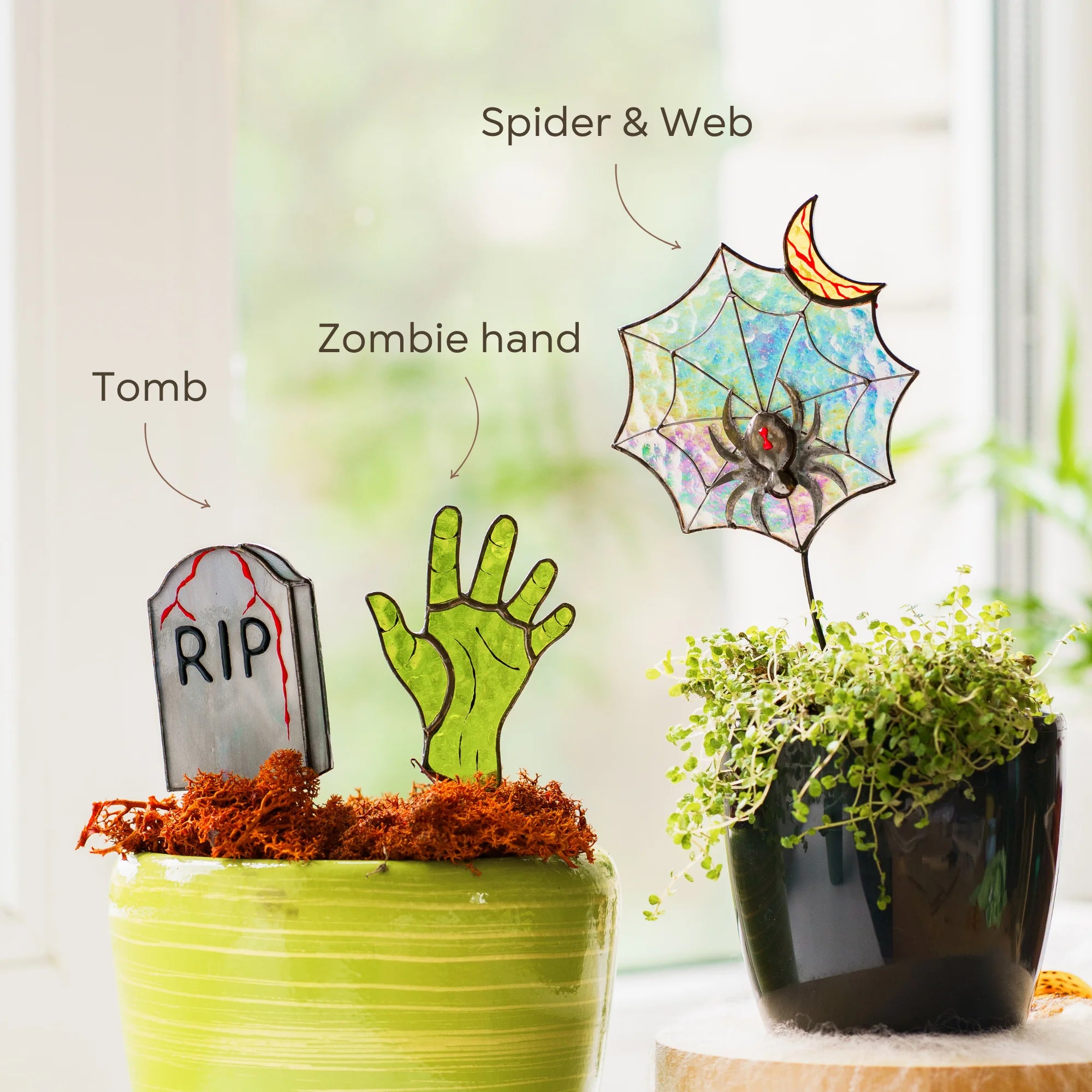 This labeled Halloween stained glass infographic highlights the tombstone, zombie hand, spider, and web, making a great gift choice