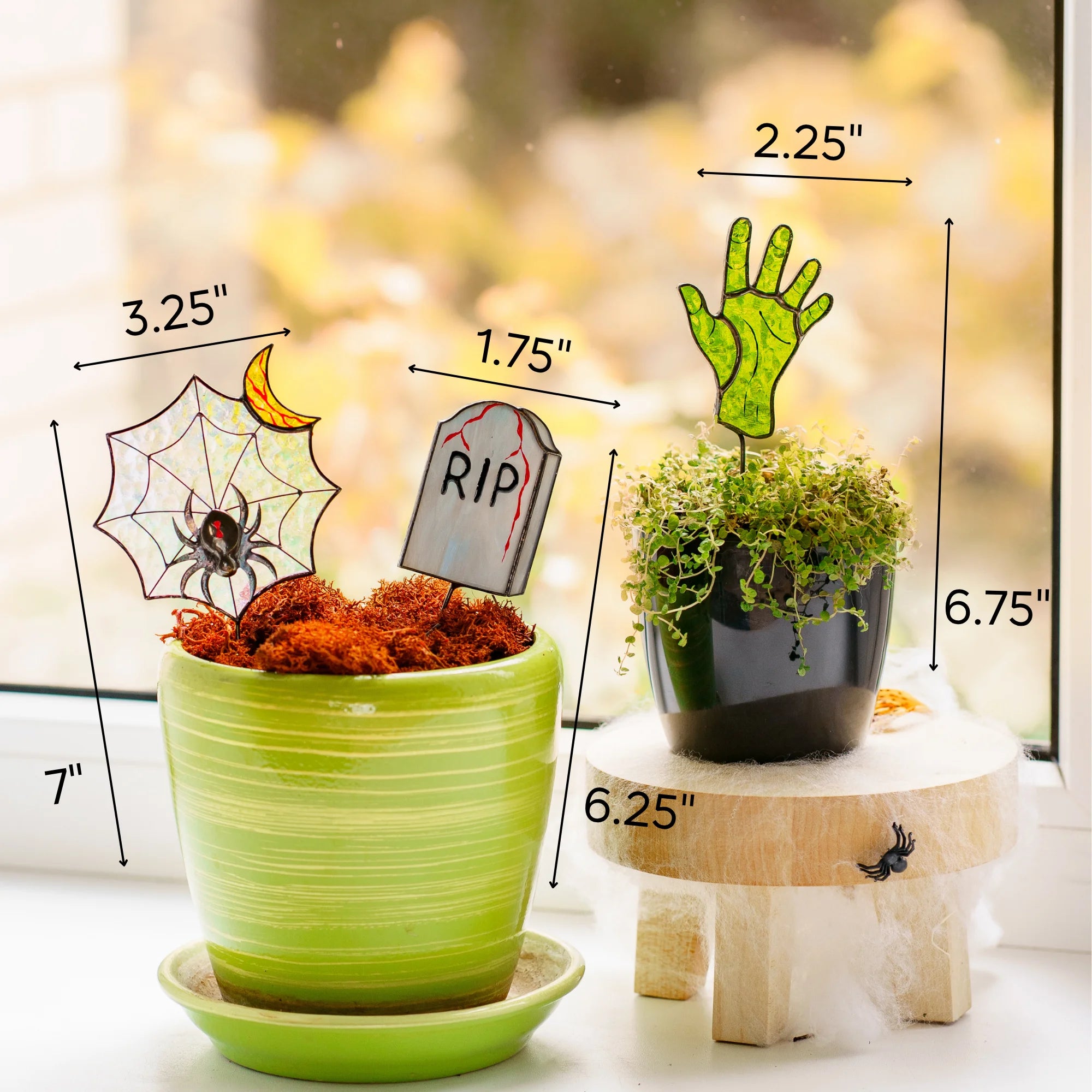 This dimensions infographic details the Halloween stained glass plant stakes: web sized 3.25 x 7 inches, tomb sized 1.75 by 6.25 inches, zombie hand sized 2.25 x 6.75 inches, showcasing them as a wonderful and memorable gift.