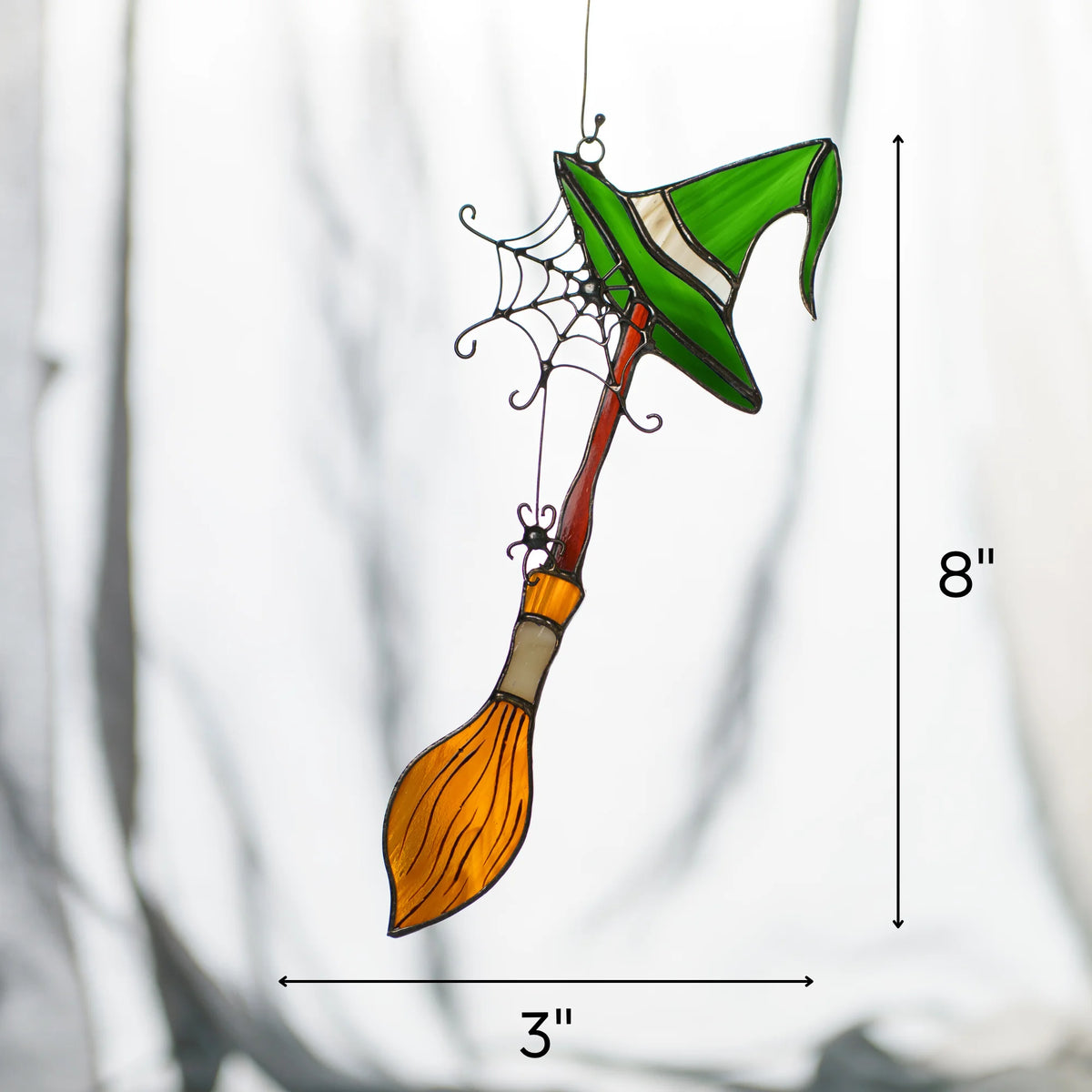 Size guide for the handmade witch broom Halloween stained glass suncatcher - 8 inches tall and 3 inches wide, a green witch hat and amber broom on a hanging wire