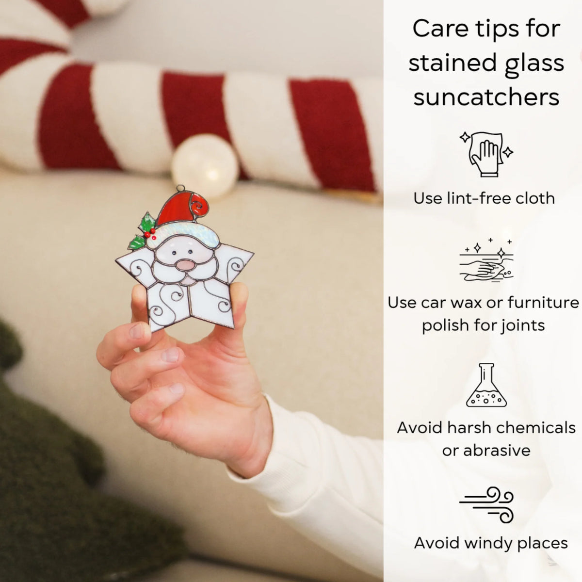 Hand holding the Snowflake Santa stained glass suncatcher by a cozy sofa - care for this handmade Christmas decor with a lint-free cloth, wax the solder joints, avoid harsh chemicals and wind