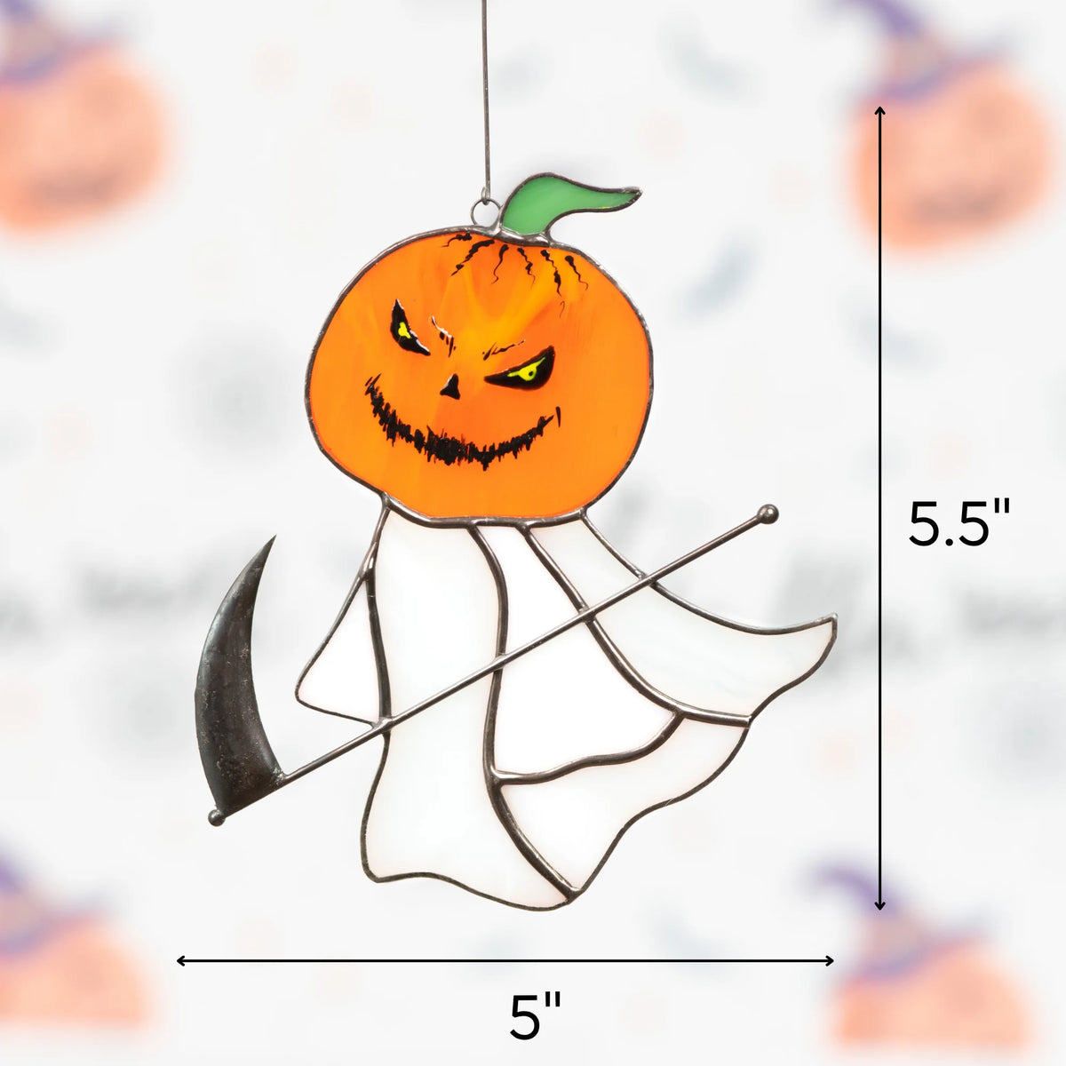 Care tips for stained glass decor beside the grim reaper pumpkin head suncatcher hanging outdoors against a blurred green backdrop.