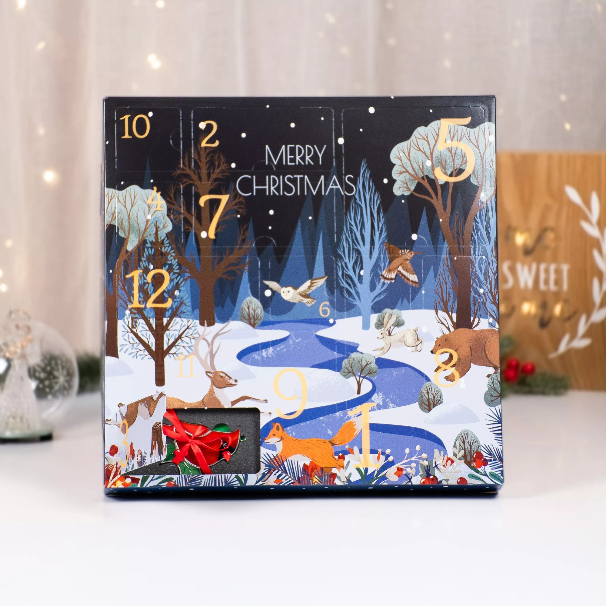 Advent calendar with 12 stained glass ornaments inside, featuring a red cardinal with ribbon tie