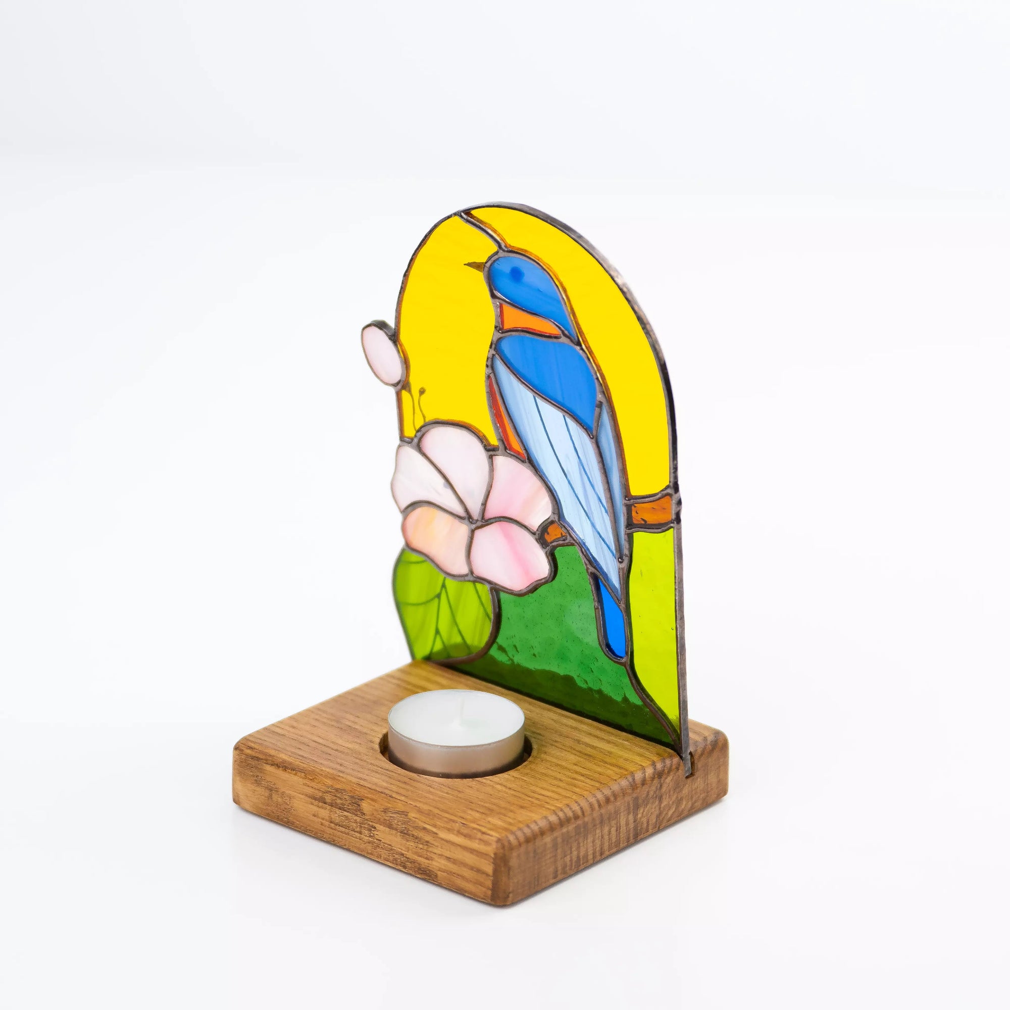 Back-view of a stained glass candle holder with bluebird