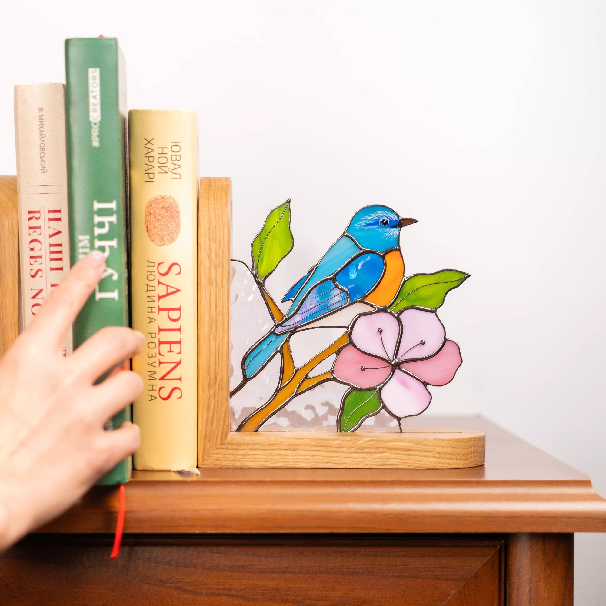 The blue bird, pink flower, and green leaves are framed by a wooden base, demonstrating the compact size and gift-ready nature of this bookend decor.