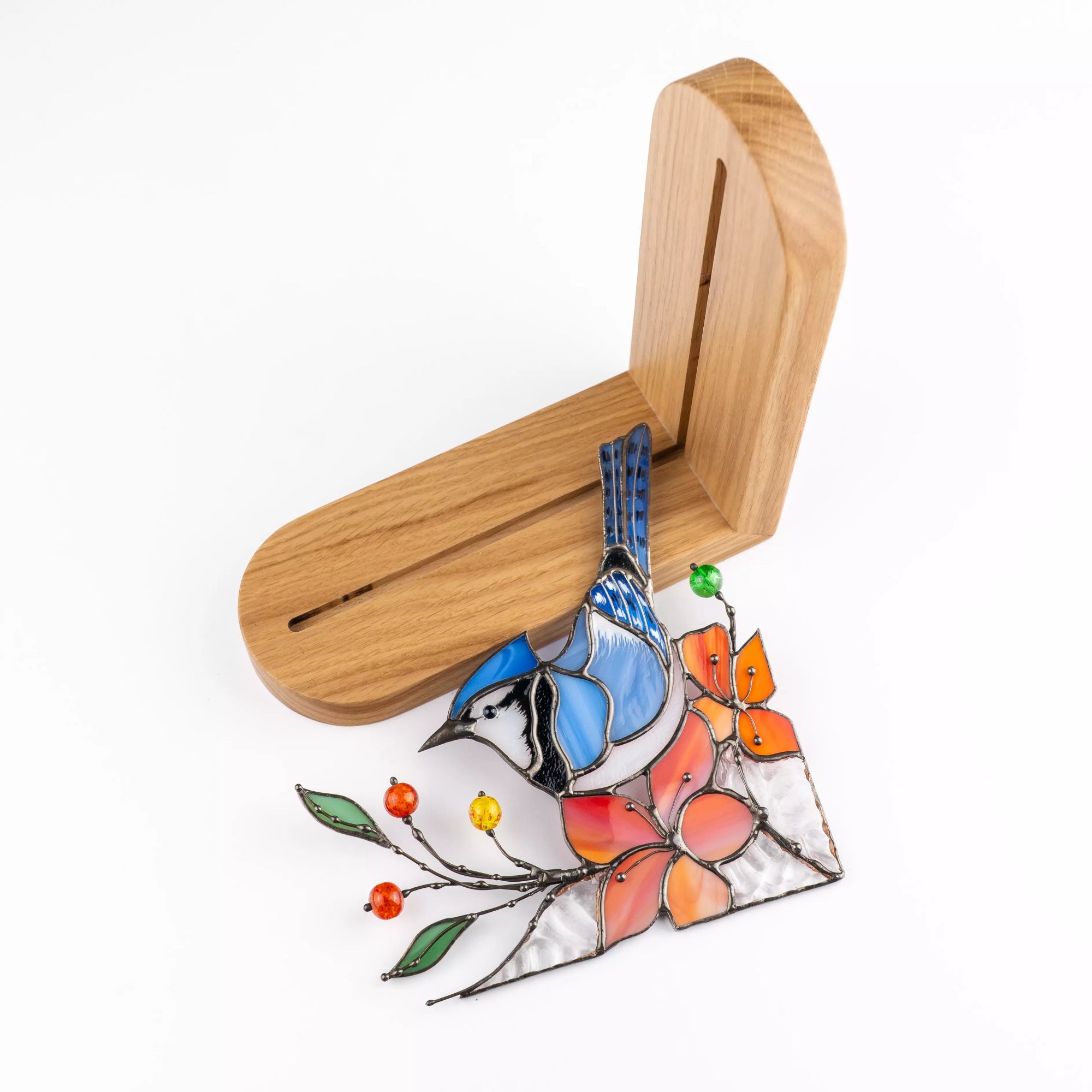 Blue jay stained glass window corner shown outside the wooden stand to display construction details.