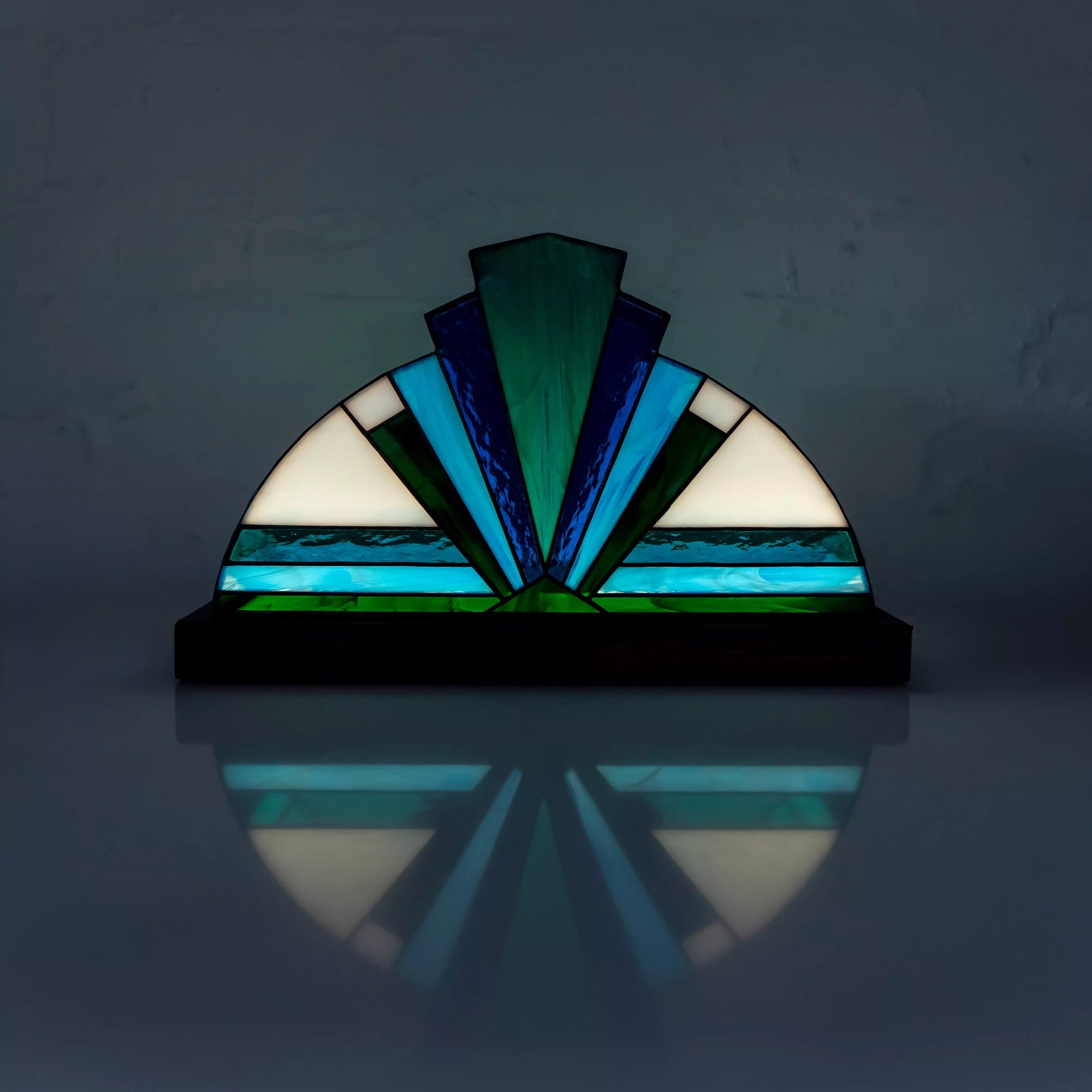 Blue stained glass table lamp with geometric glass details on a wooden base, handmade home decor accent.