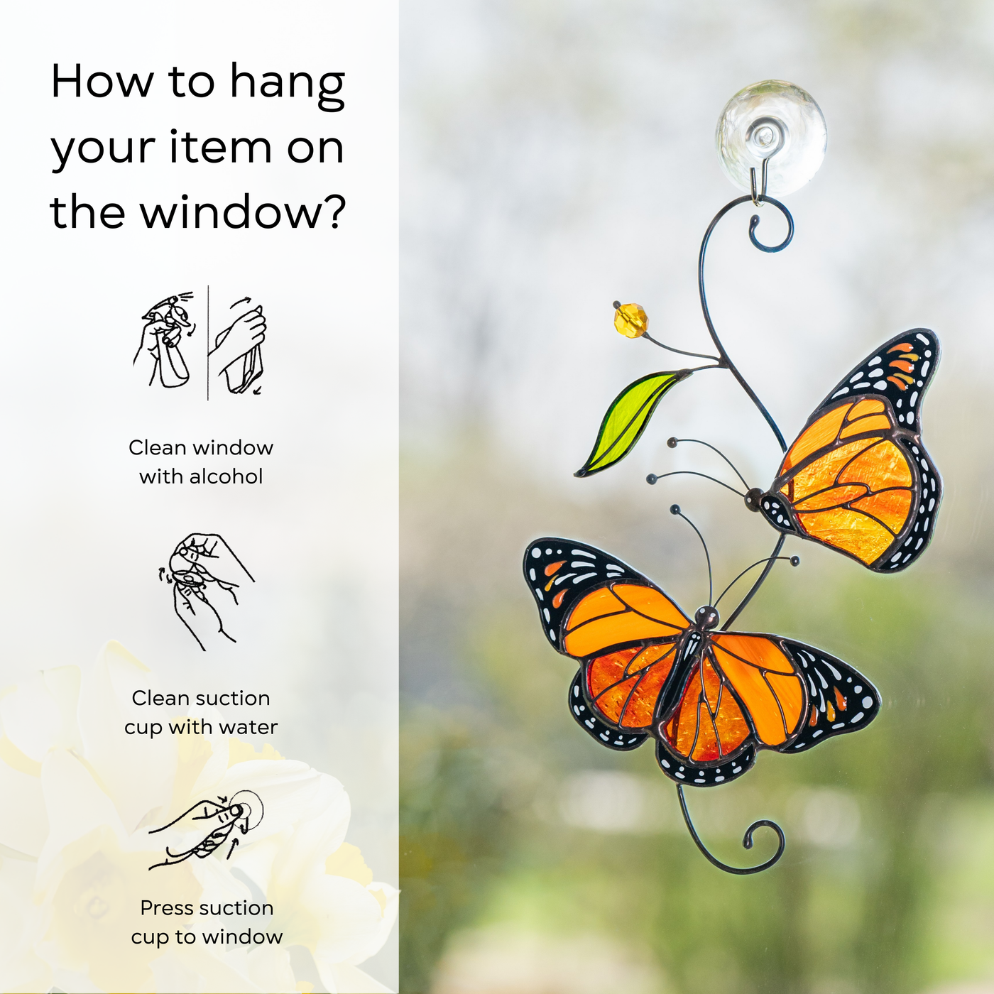 Monarch stained glass suncatcher attached to a window, with sunlight highlighting the vibrant orange wings, instruction beside: clean window and suction cup, press a cup to the surface.