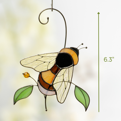 Stained glass bumble bee with amber wings and a green leaf accent, 6.3 inches in height.