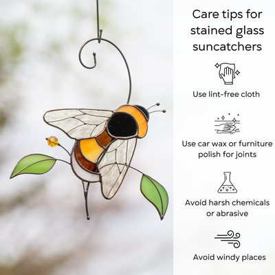 Glass bee suncatcher displayed outside, with care instructions for stained glass decor beside: use lint-free cloth, use wax polish for joints, no harsh cleaners, avoid wind.