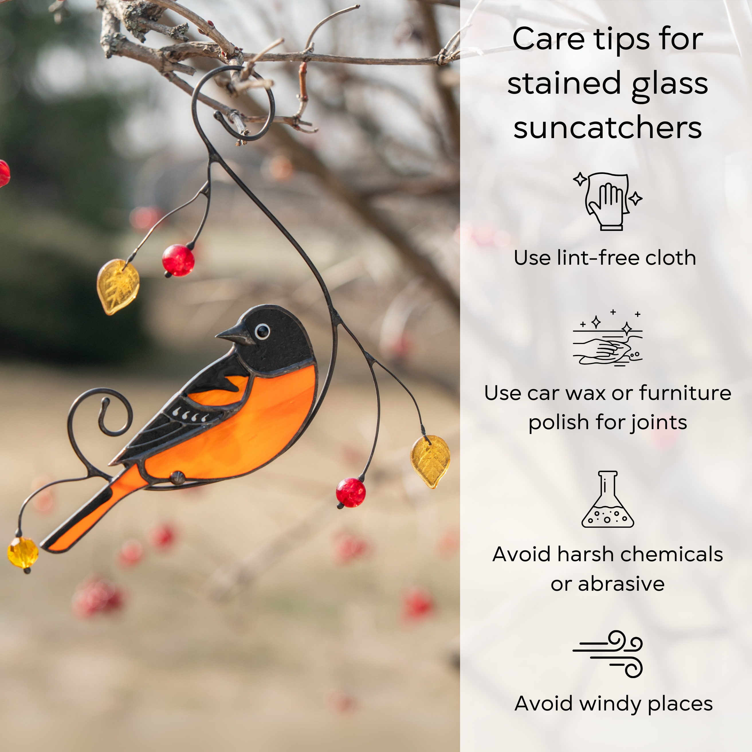 Oriole suncatcher on outdoor branch next to illustrated tips for cleaning and protecting stained glass: use lint-free cloth, use wax polish for joints, no harsh cleaners, avoid wind.