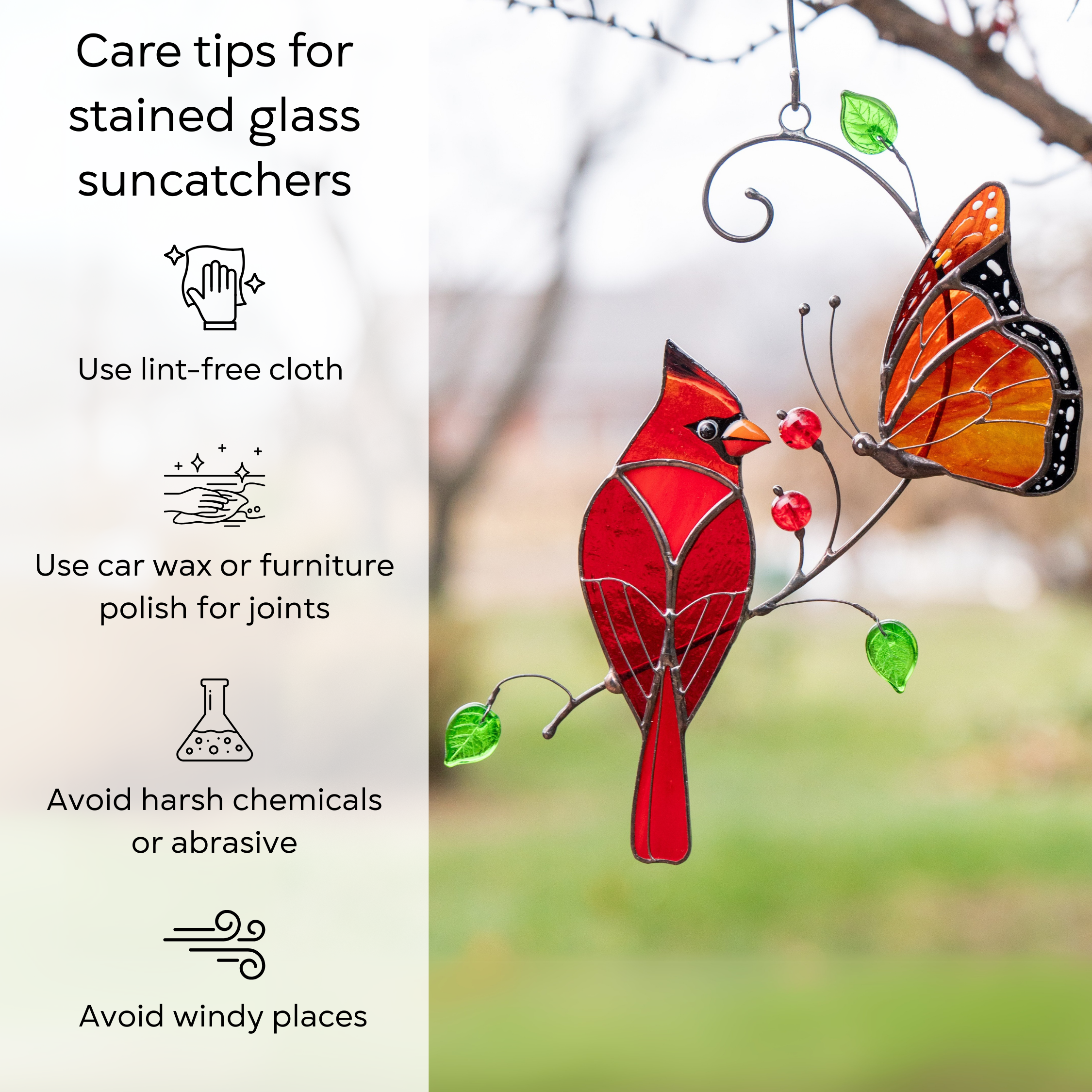 Stained glass suncatcher with a red cardinal and orange monarch butterfly hanging outdoors next to care instructions: use lint-free cloth, use wax polish for joints, no harsh cleaners, avoid wind.