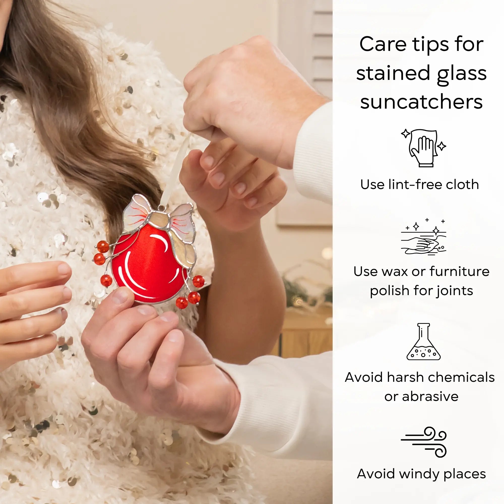 Care tips for stained glass suncatchers with a close-up of a red suncatcher held by hands: use lint-free cloth, polish joints with car wax or furniture polish, avoid harsh chemicals, and windy places.