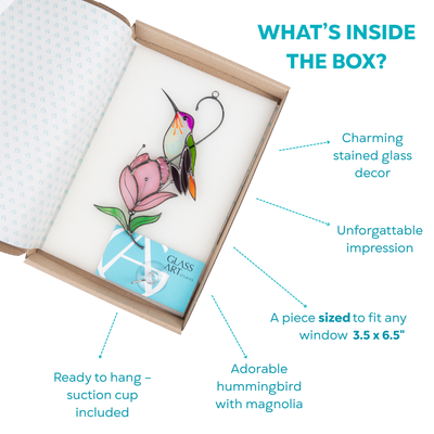 A stained glass hummingbird and pink magnolia set displayed inside a gift box with a suction cup included.